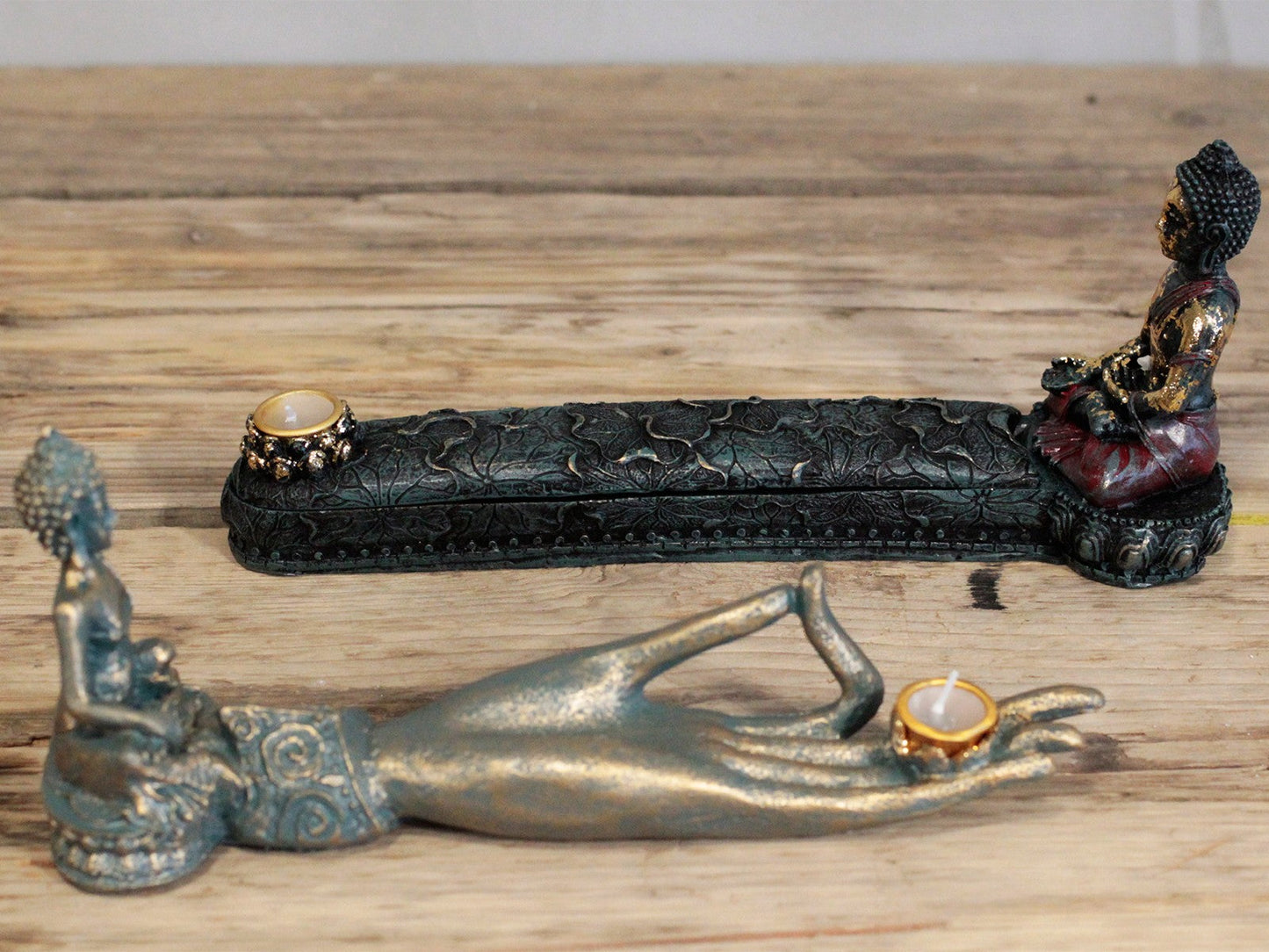 Resin Incense Burner - Buddha with long embossed dark tray and gold-toned holder, displayed beside a hand-shaped burner by Quintessential Holistic Health Ltd