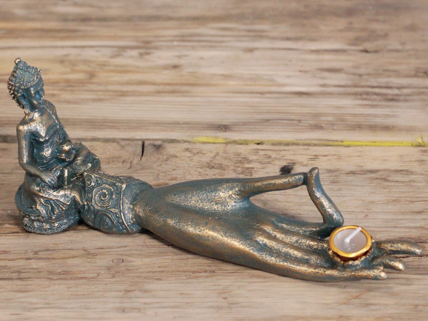 Resin Incense Burner - Buddha Hand, 25 × 7 × 11cm with seated figure, bronze-toned arm and round orange-centred holder on the palm by Quintessential Holistic Health Ltd