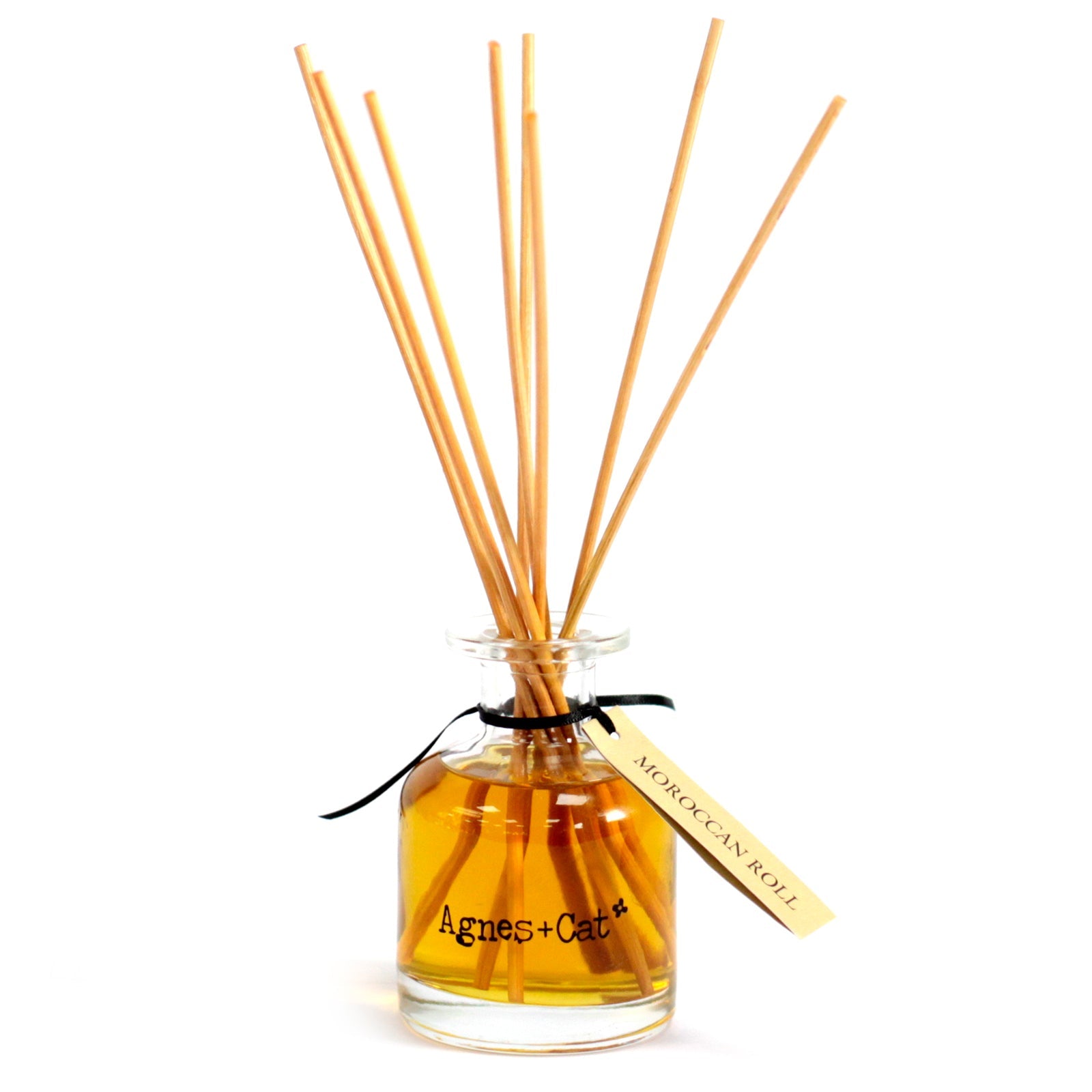 Reed Diffuser - Moroccan Roll - 140ml, amber bottle with six widely fanned natural-coloured reeds and a cream hanging tag by Quintessential Holistic Health Ltd