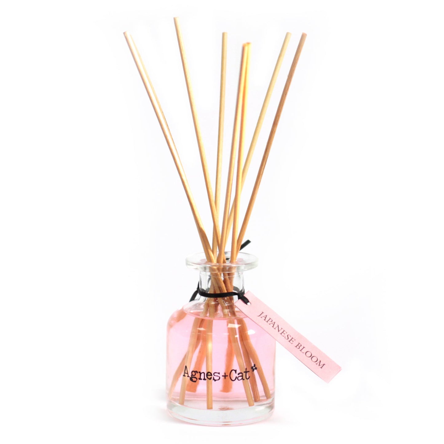 Reed Diffuser - Japanese Bloom - 140ml, pale pink bottle with six natural-coloured reeds and a pink hanging tag by Quintessential Holistic Health Ltd
