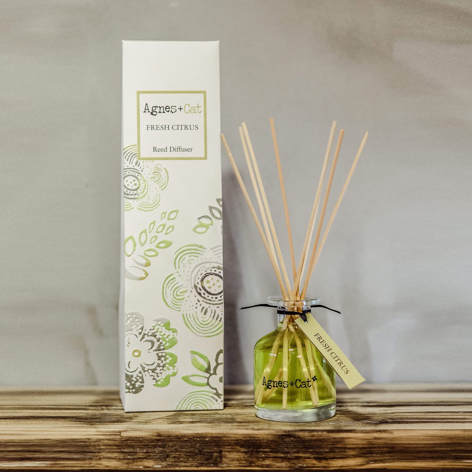 Reed Diffuser - Fresh Citrus - 140ml, green bottle with fanned natural-coloured reeds beside a tall illustrated box by Quintessential Holistic Health Ltd
