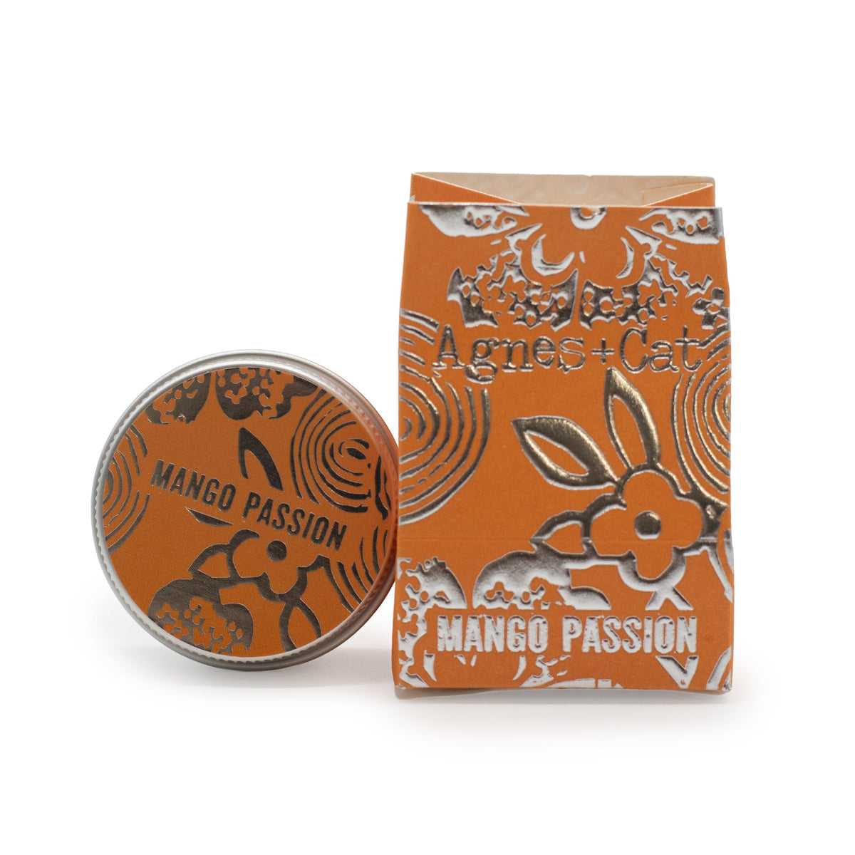 Hand-Poured Vegan-Friendly Natural Lip - Mango and Passion Fruit, with an orange illustrated tin beside a matching box, by Quintessential Holistic Health Ltd