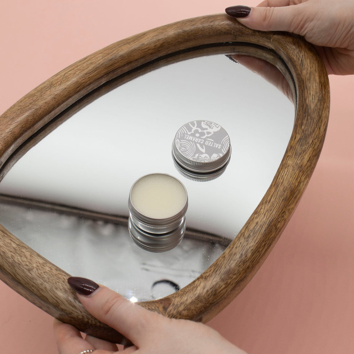 Hand-Poured Vegan-Friendly Natural Lip Balm - Grapefruit, open tin and silver lid reflected in an oval wooden-framed mirror, by Quintessential Holistic Health Ltd