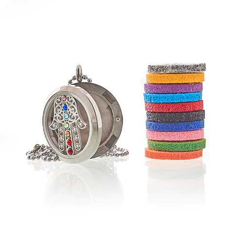 Aromatherapy Essential Oil Chain Necklace - Hamsa Chakra - Large, open round pendant beside its chain and a tall stack of multicoloured pads by Quintessential Holistic Health Ltd