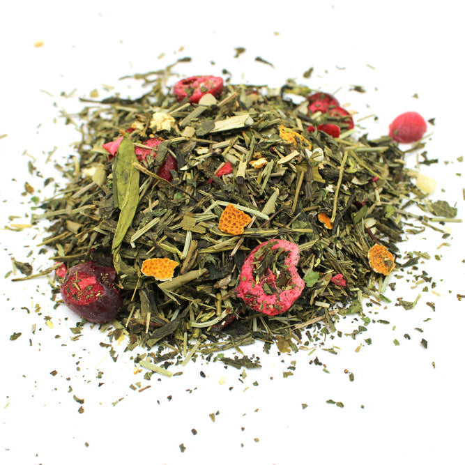 Green Dragon green tea blend, loose mound with red berries and orange pieces from Quintessential Holistic Health.
