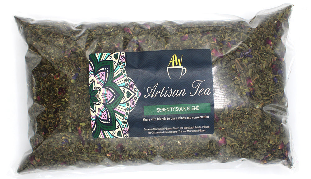 In a clear rectangular bag with a dark Artisan Tea label; Serenity Souk green tea blend from Quintessential Holistic Health.