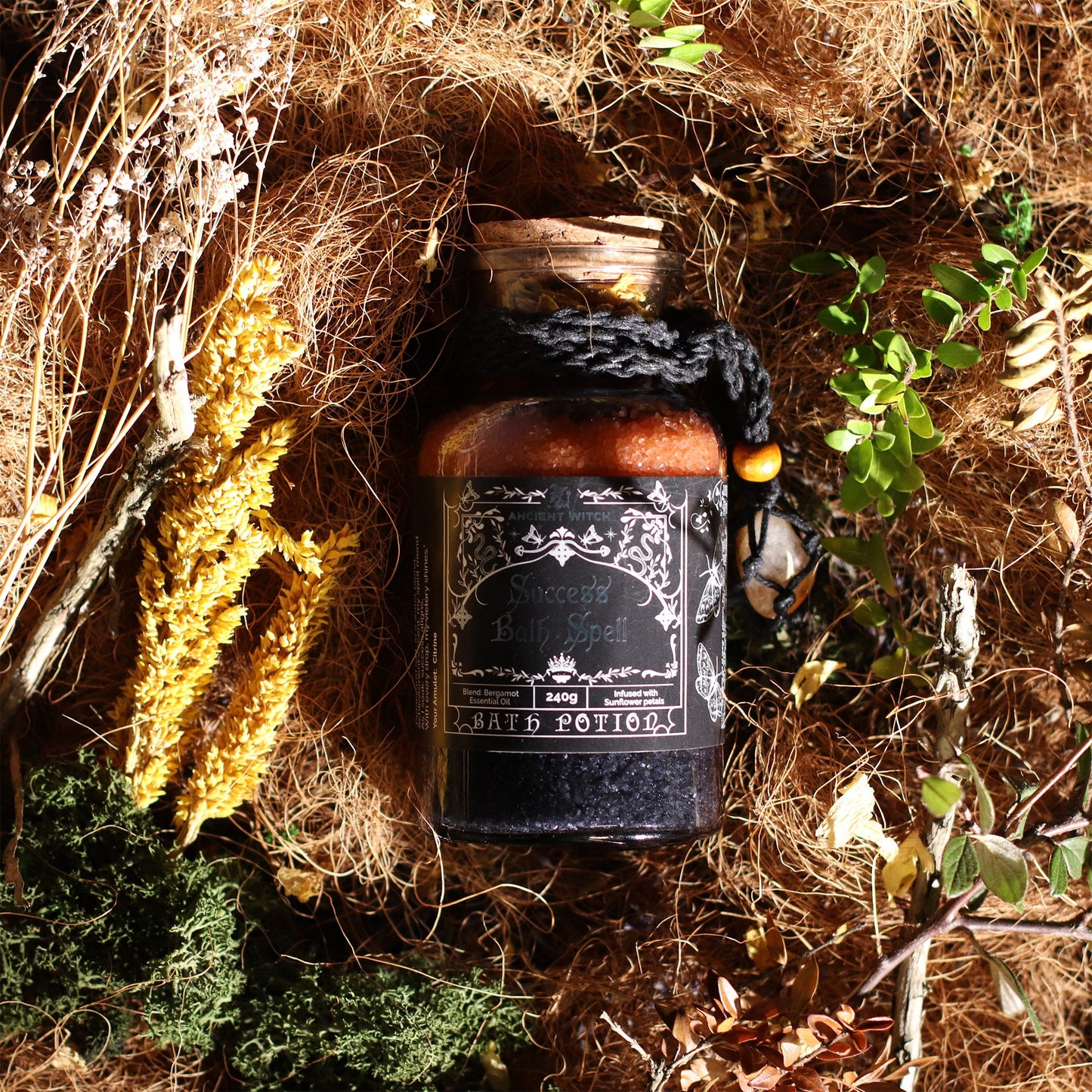 Vegan Bath Spell Potion & Citrine Crystal Amulet - Success, corked bottle resting among moss, dry grasses and tree roots, by Quintessential Holistic Health Ltd
