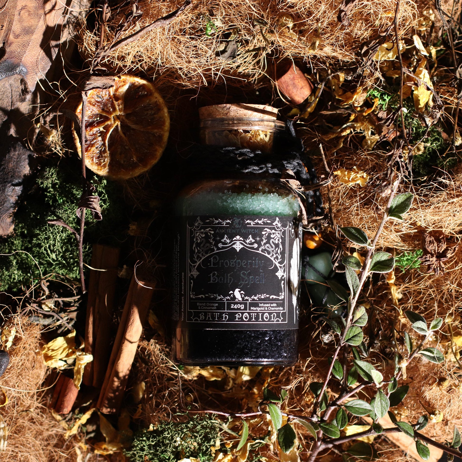 Vegan Bath Spell Potion & Aventurine Crystal Amulet - Prosperity, corked bottle nestled among moss, leaves and rustic objects, by Quintessential Holistic Health Ltd
