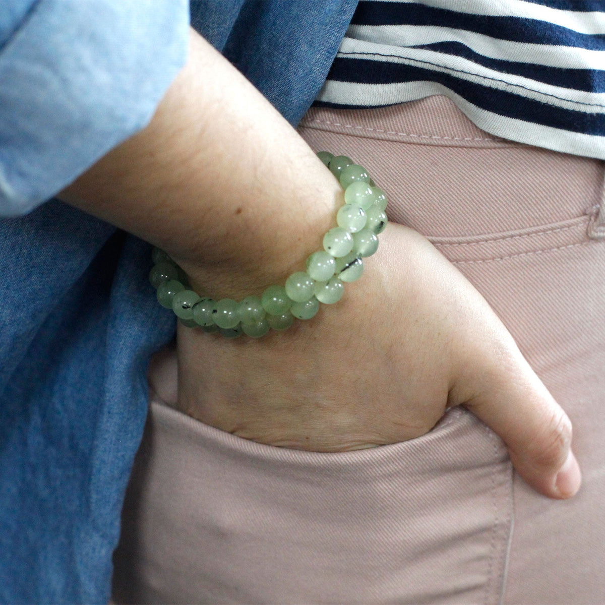 Gemstone Power Bracelet - Jade with translucent pale green round beads worn around a wrist, by Quintessential Holistic Health Ltd