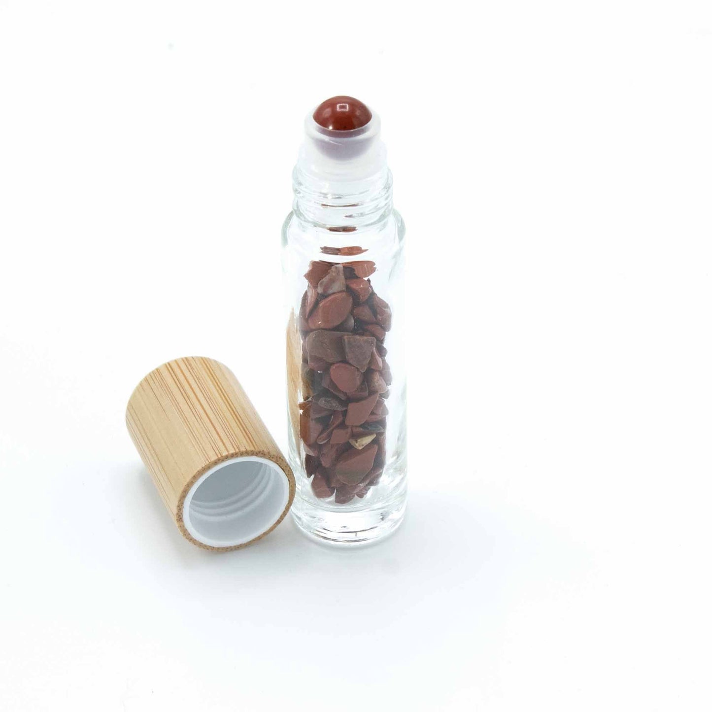Red Jasper 10ml gemstone roller bottle with wooden cap and visible stone pieces, main product view from Quintessential Holistic Health.