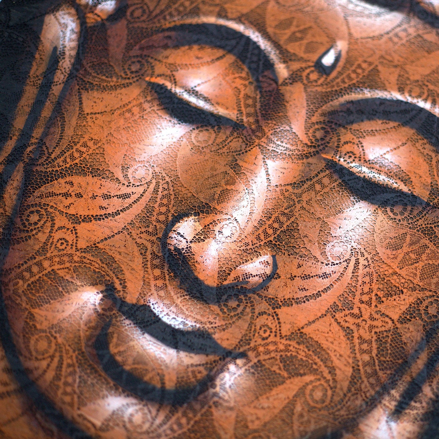 Hand-Painted Buddha Painting - Copper Brocade Detail, close-up of the closed eyes, nose, lips and ornate copper patterning, by Quintessential Holistic Health Ltd