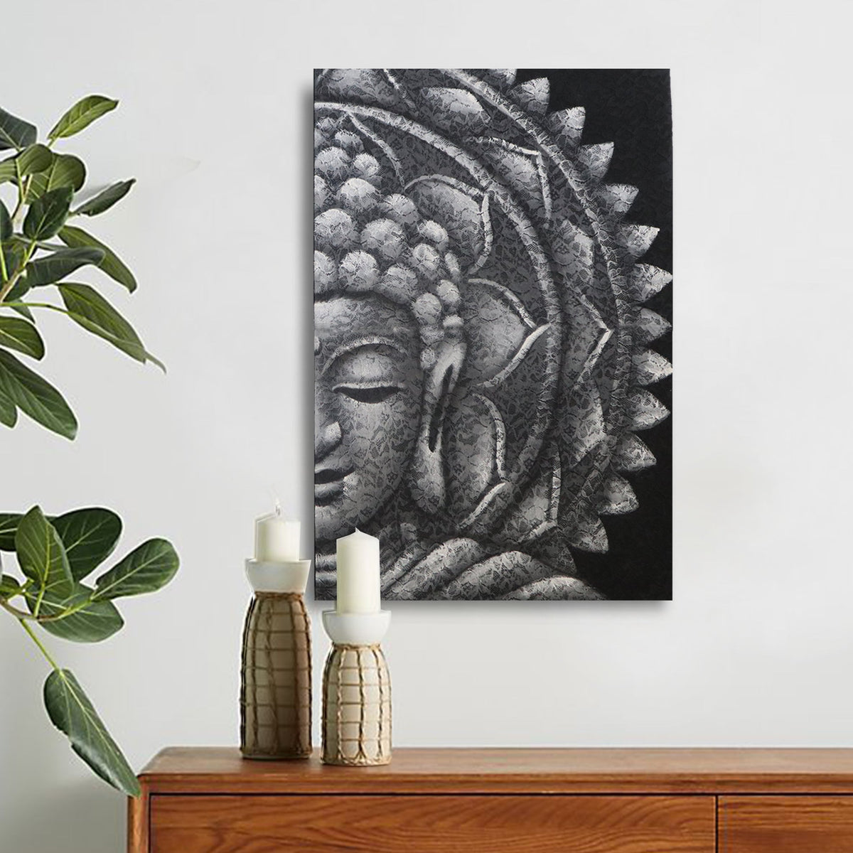 Hand-Painted Grey Half Buddha Mandala - 60 × 80cm displayed above a wooden cabinet beside green foliage and two bottles by Quintessential Holistic Health Ltd