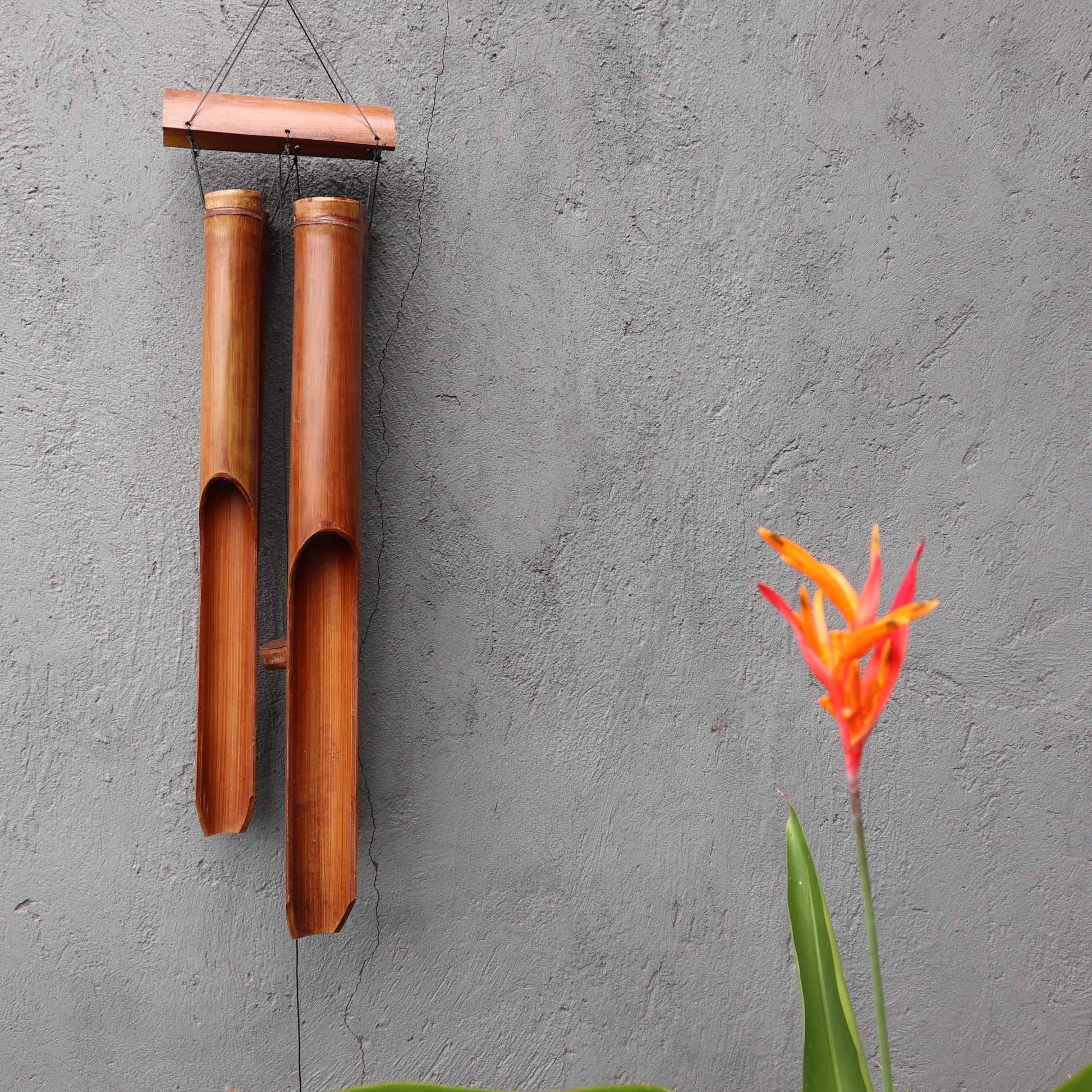 Bamboo Wind Chime - 4 Large Tubes - Natural - 105 cm with four long brown tubes suspended from a rectangular top bar by Quintessential Holistic Health Ltd