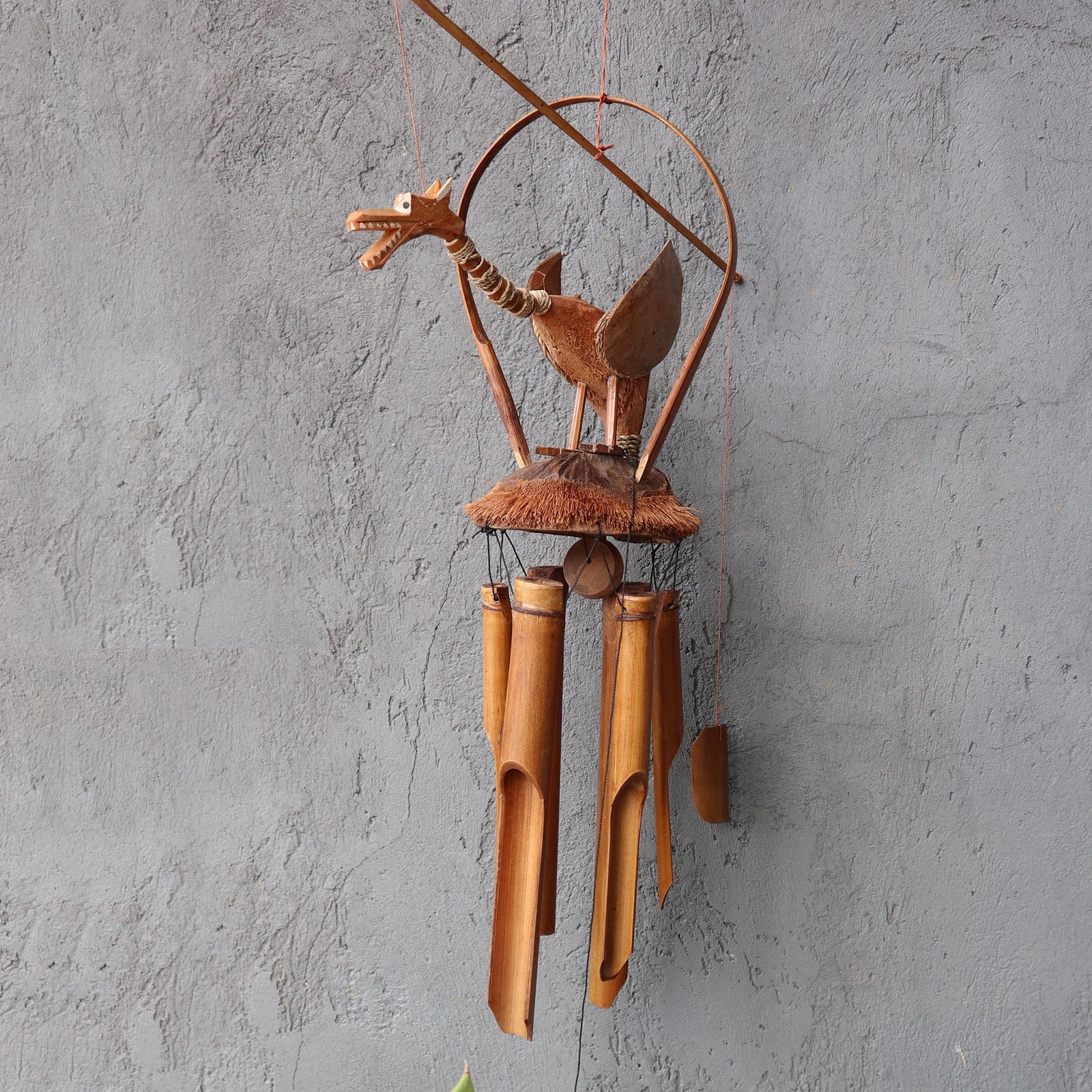 Handcrafted Bamboo Wind Chime - Natural - Dragon with a carved winged dragon above four brown hanging tubes by Quintessential Holistic Health Ltd