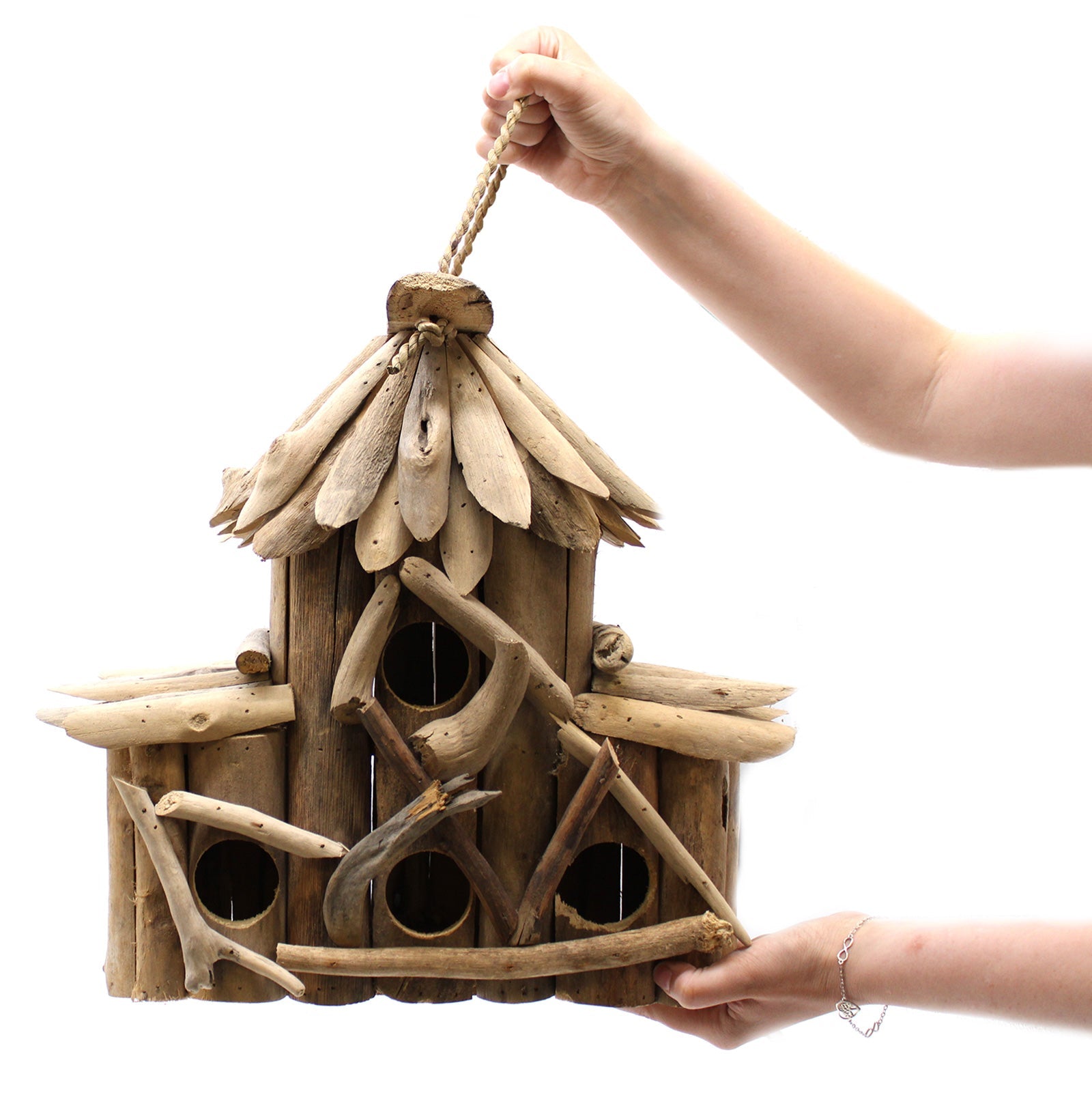 Handmade Recycled Driftwood Bird Box - Croft, held by its hanging cord with four openings and rustic branch details, by Quintessential Holistic Health Ltd