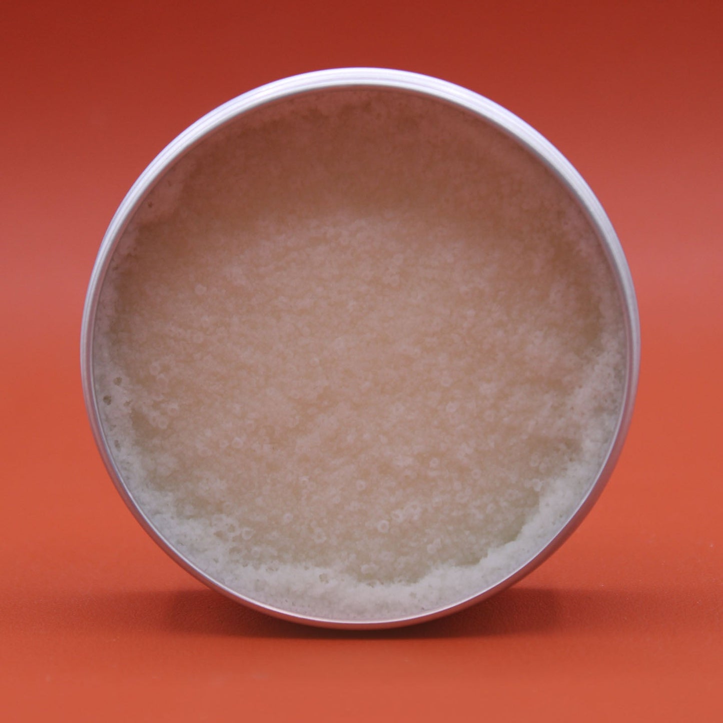 Lavender Vegan-Friendly Shea Body Butter 90g in an open round tin with a pale smooth surface and uneven edge by Quintessential Holistic Health Ltd