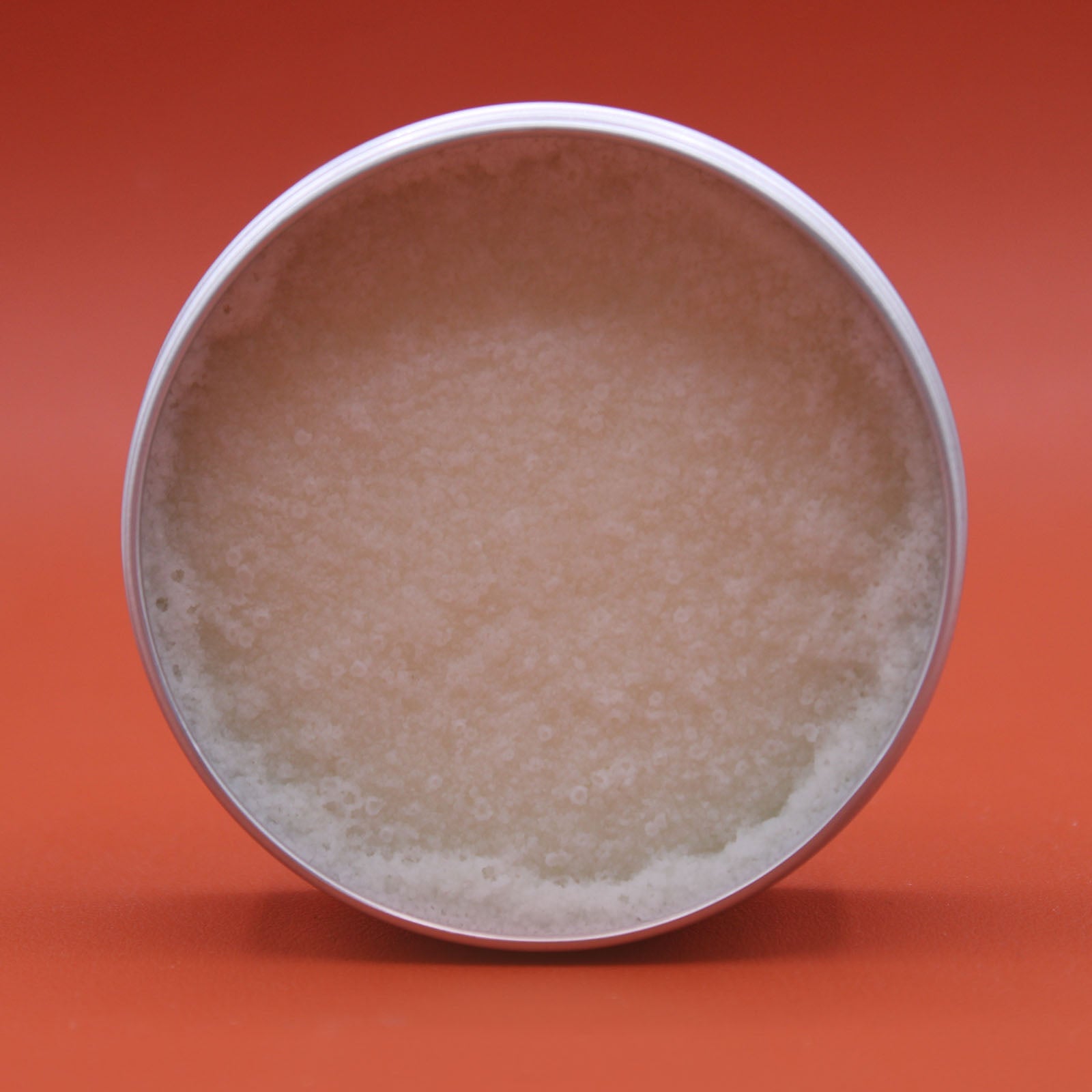 Lavender Vegan-Friendly Shea Body Butter 90g in an open round tin with a pale smooth surface and uneven edge by Quintessential Holistic Health Ltd
