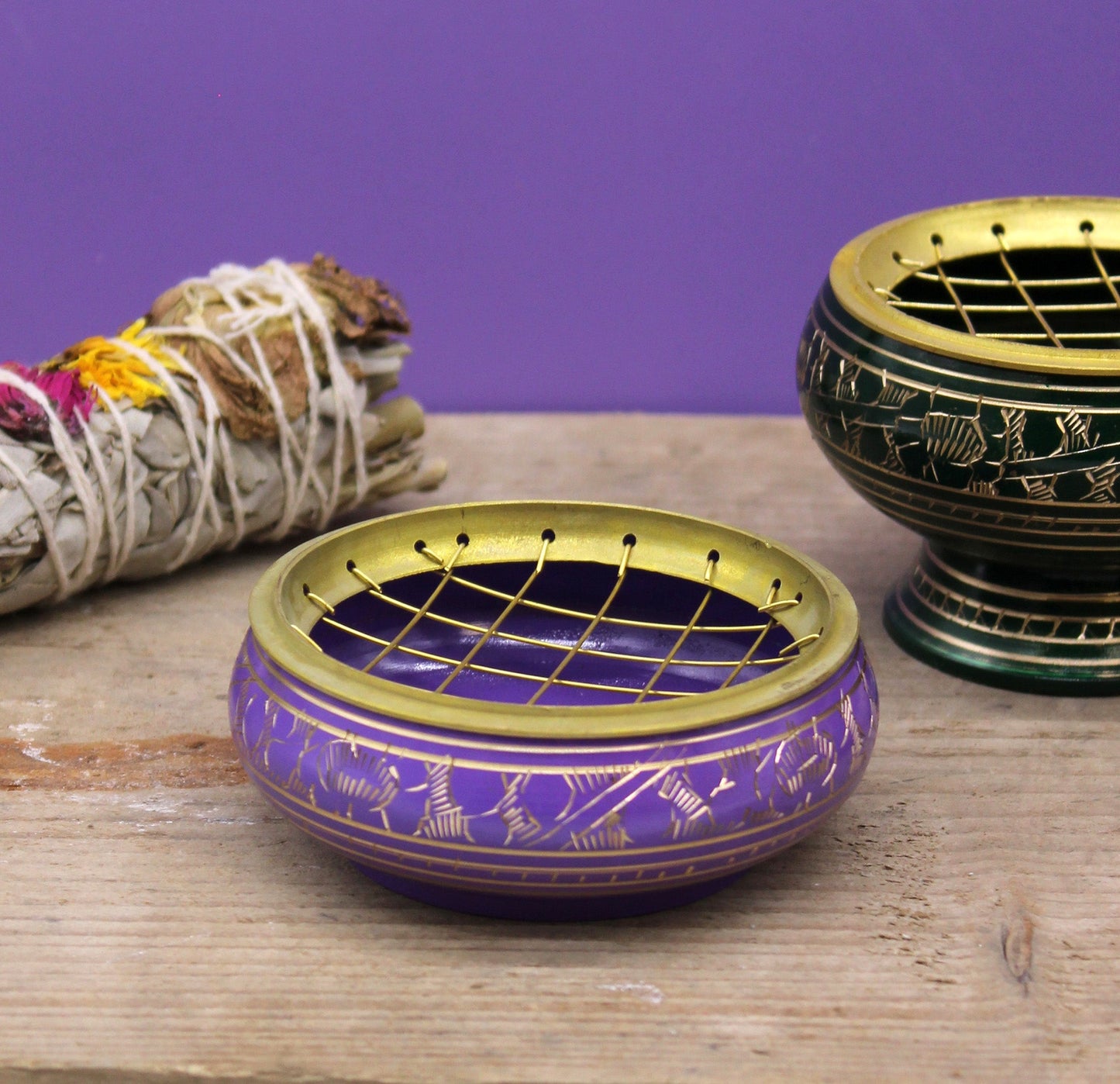 Handmade Brass Charcoal Burner Jar - Crown Chakra, in purple with a lattice lid, beside bundled herbs and another jar by Quintessential Holistic Health Ltd
