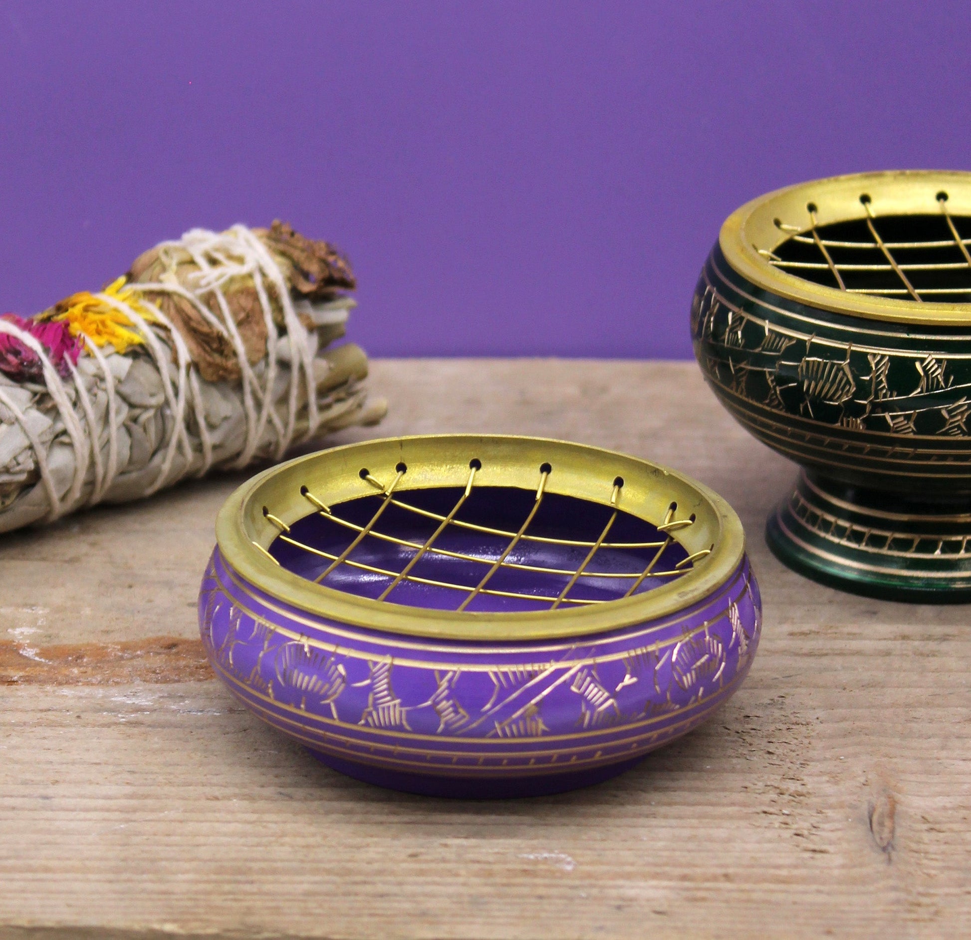 Handmade Brass Charcoal Burner Jar - Crown Chakra, in purple with a lattice lid, beside bundled herbs and another jar by Quintessential Holistic Health Ltd