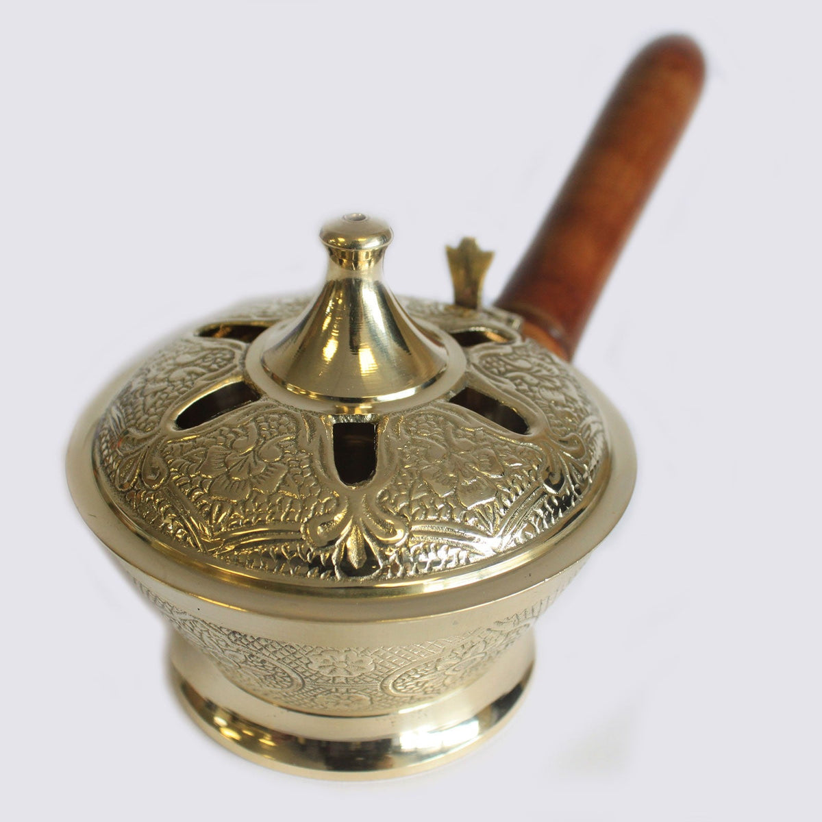 Small Ornate Brass Incense Burner with Handle featuring floral engraving, a pointed lid and brown wooden grip by Quintessential Holistic Health Ltd