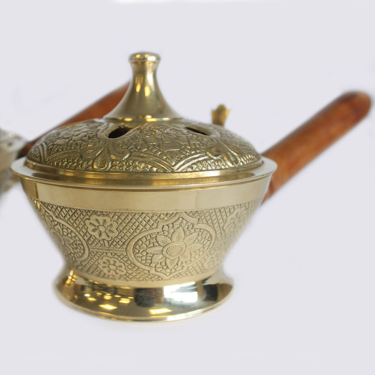 Small Ornate Brass Incense Burner with Handle with an engraved bowl, vented lid and long brown wooden grip by Quintessential Holistic Health Ltd