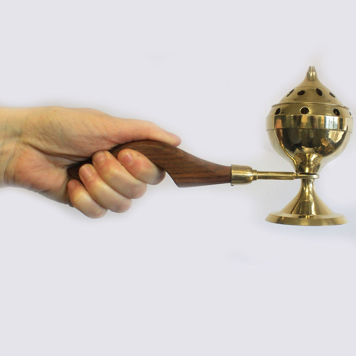 Small Plain Brass Incense Burner with Handle, held by its curved wooden grip with the perforated lid fitted by Quintessential Holistic Health Ltd