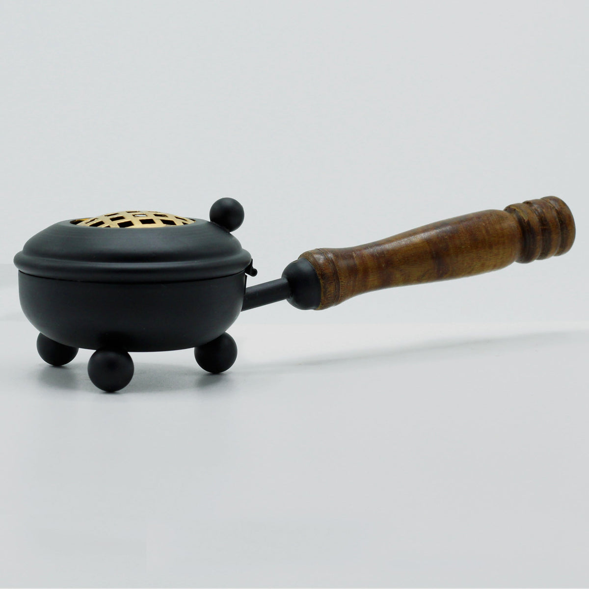 Cast Iron Incense Burner with Gold Detail - Medium, standing on three rounded feet with its pierced lid closed by Quintessential Holistic Health Ltd