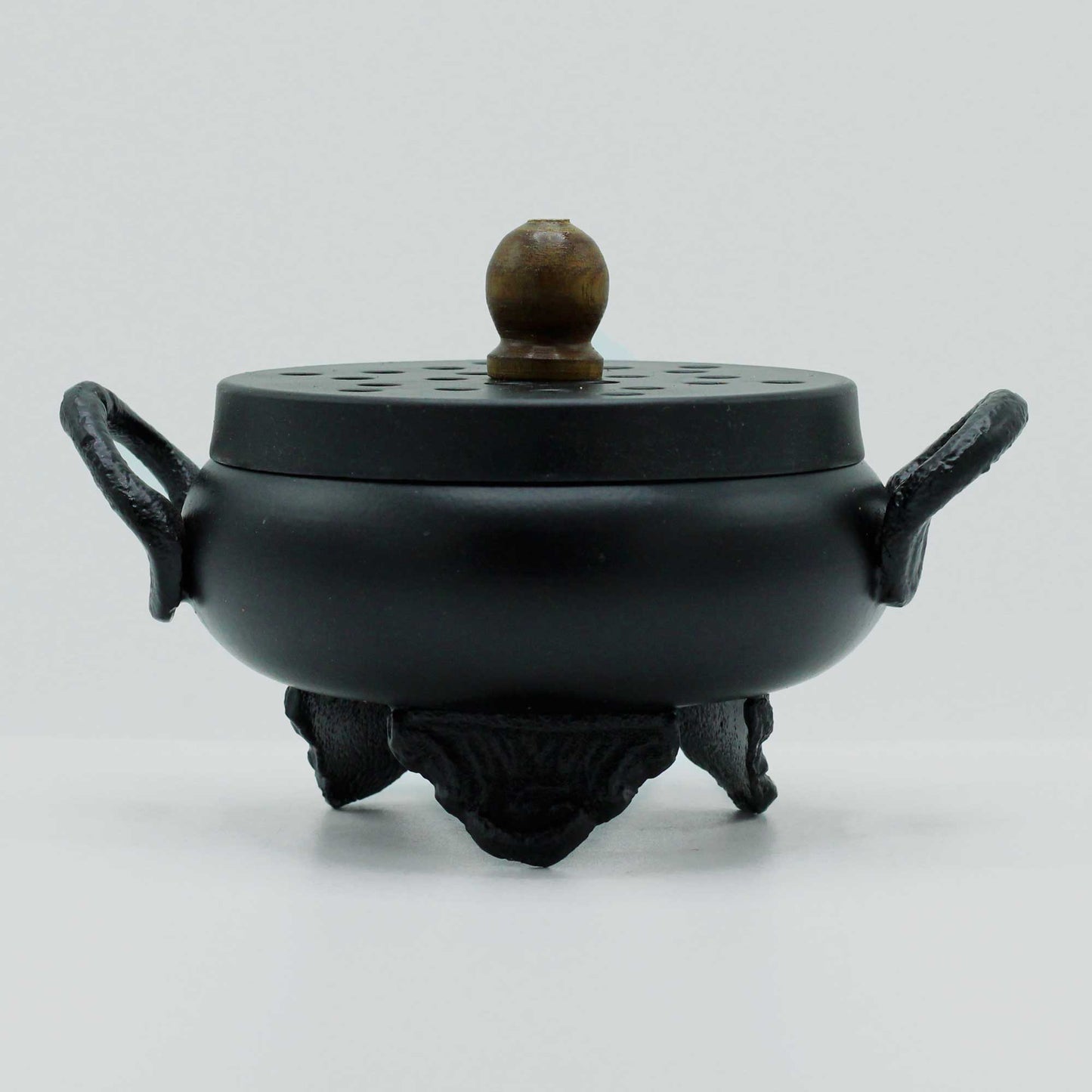 Cast Iron Incense Burner - Classic Cauldron, closed black pot with side loops, raised feet and a round brown lid knob by Quintessential Holistic Health Ltd
