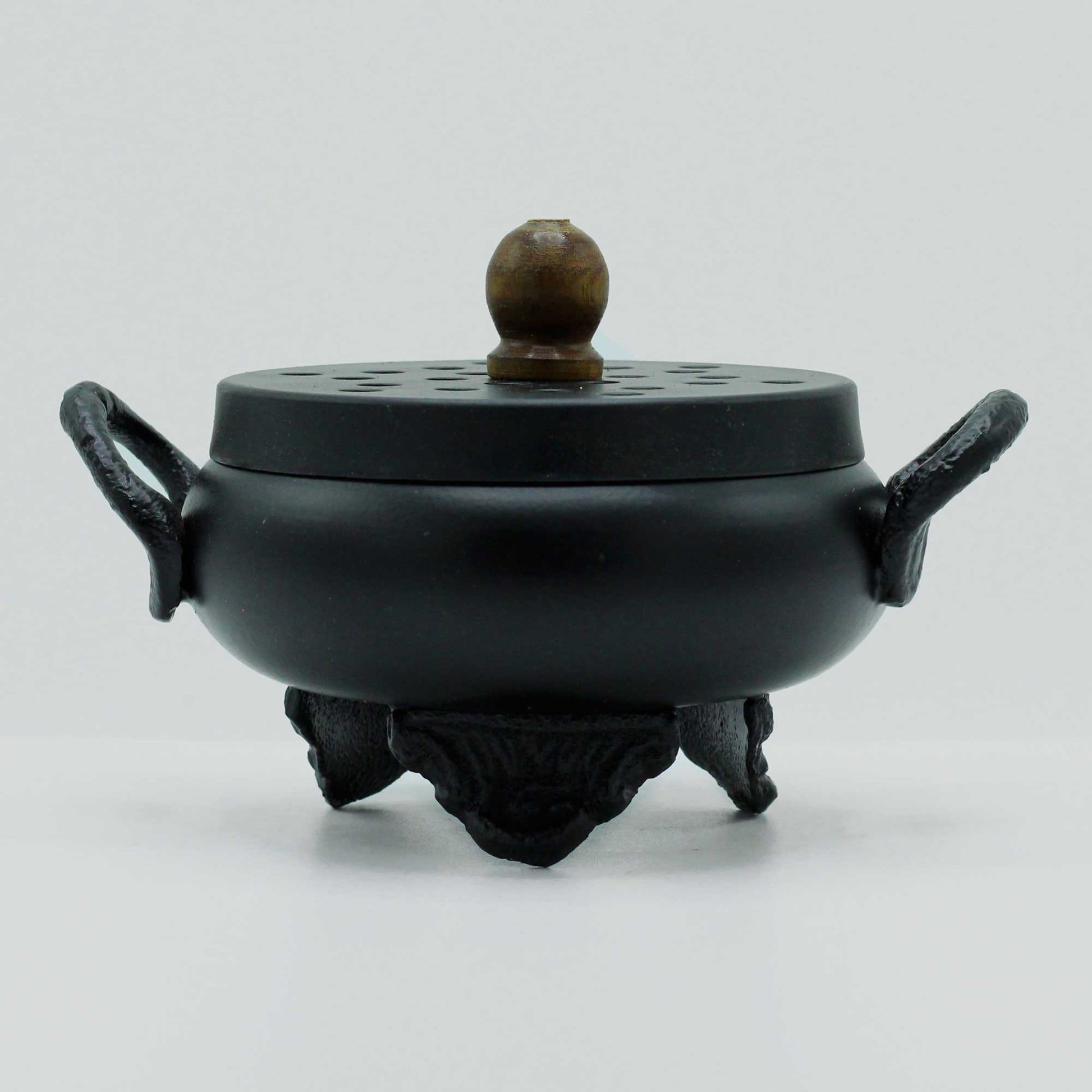 Cast Iron Incense Burner - Classic Cauldron, closed black pot with side loops, raised feet and a round brown lid knob by Quintessential Holistic Health Ltd