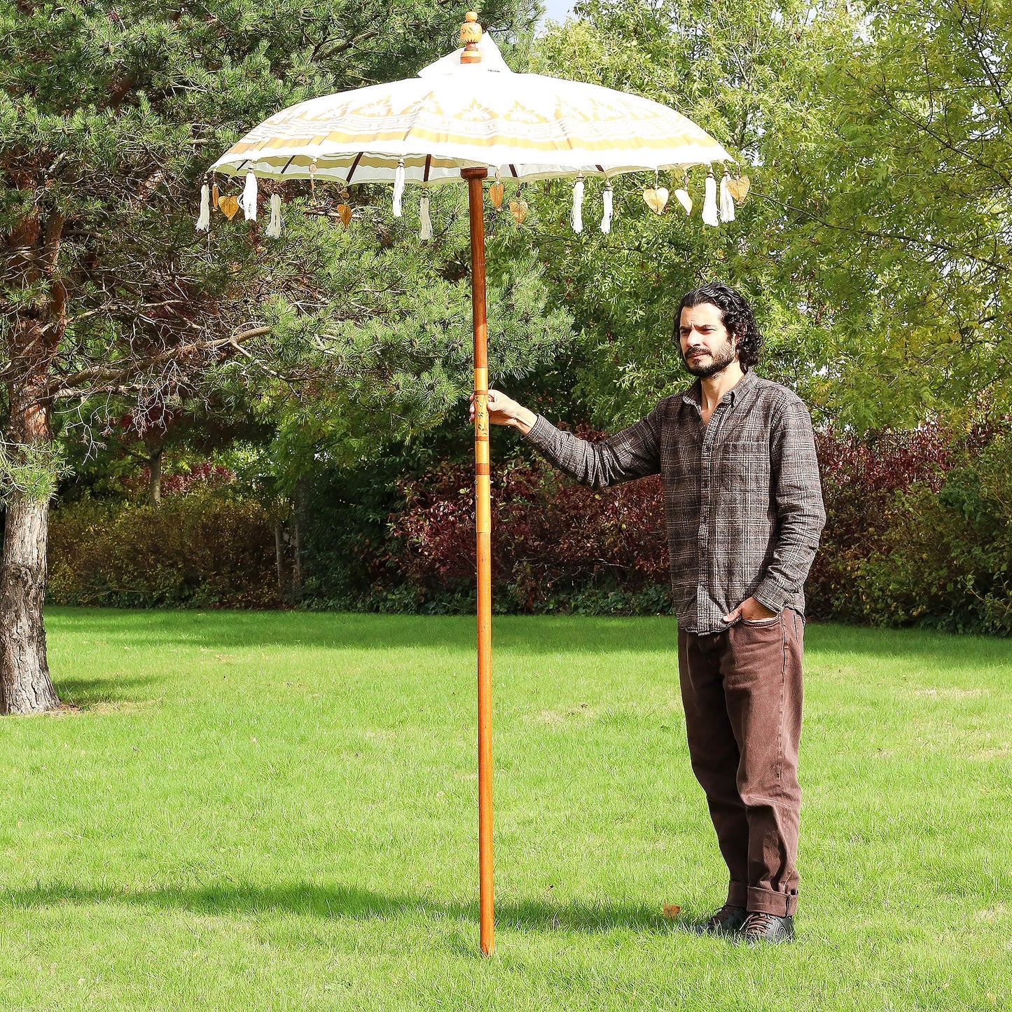 Handcrafted Decorative Parasol - Medium - Natural with cream canopy, golden pole and hanging white tassels, held upright by Quintessential Holistic Health Ltd