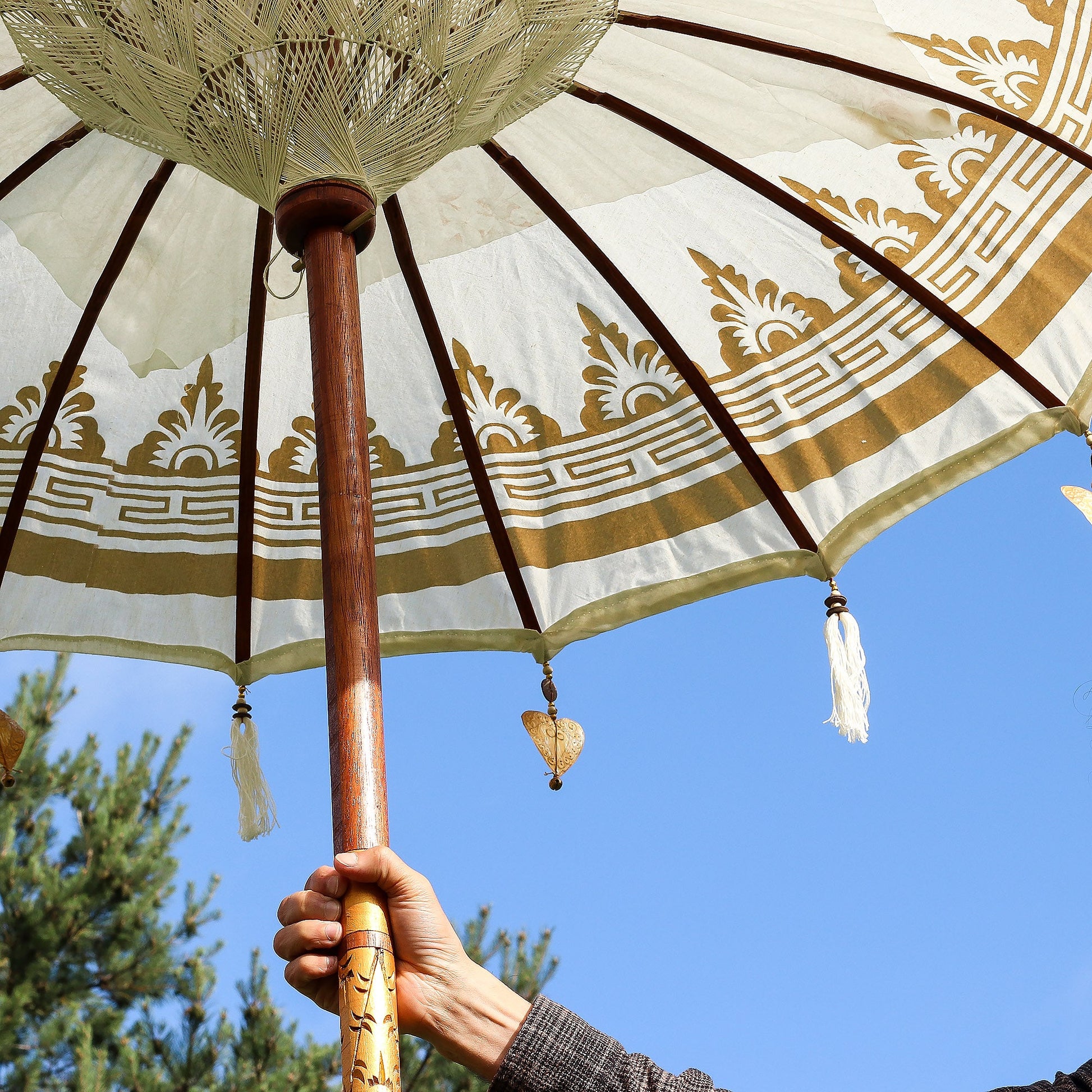 Handcrafted Decorative Parasol - Medium - Natural, viewed from underneath with gold motifs, spokes and hanging tassels by Quintessential Holistic Health Ltd
