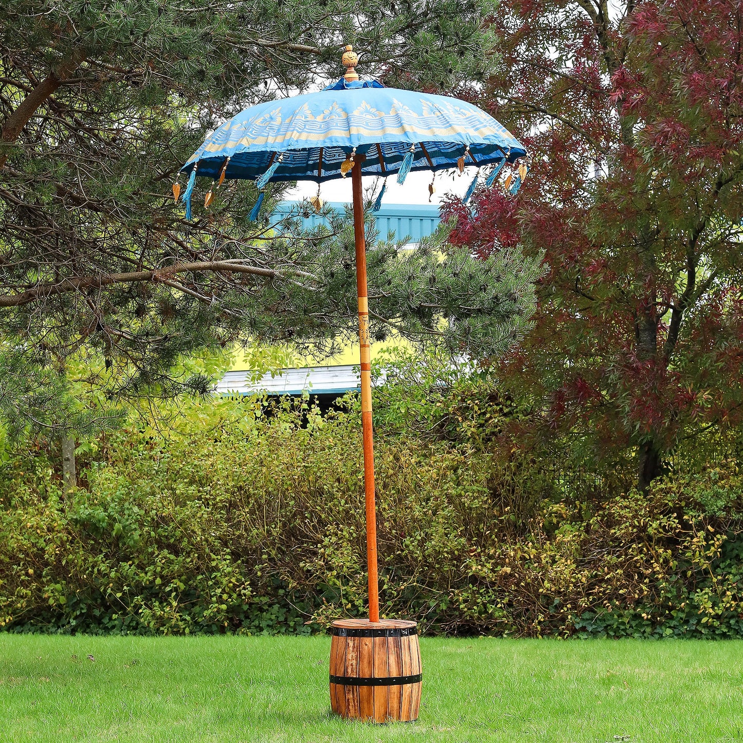 Handcrafted Decorative Parasol - Medium - Turquoise with blue canopy and dangling ornaments, standing in a wooden base by Quintessential Holistic Health Ltd