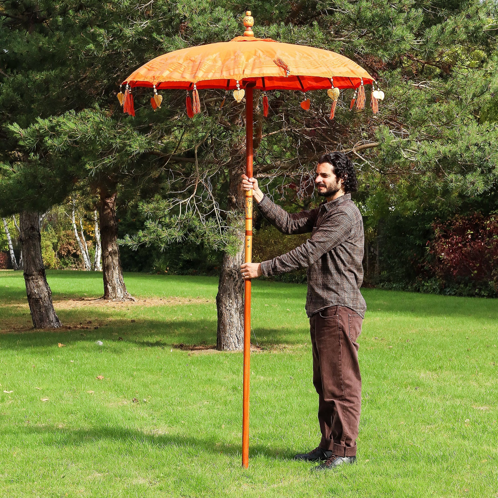 Handcrafted Decorative Parasol - Medium - Orange Decor with orange canopy, dark motifs and tasselled trim, held upright by Quintessential Holistic Health Ltd