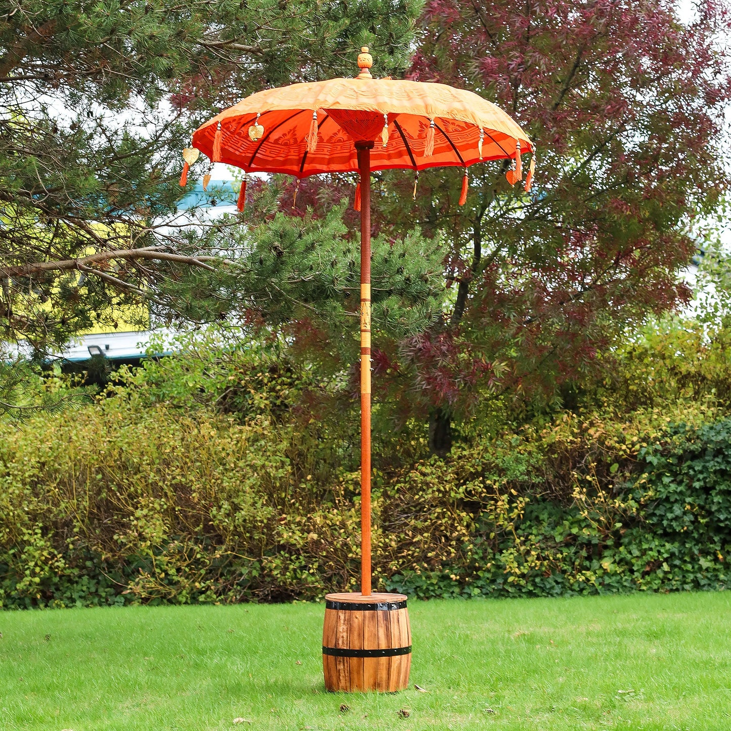 Handcrafted Decorative Parasol - Medium - Orange Decor with orange canopy and tassels, standing in a wooden base by Quintessential Holistic Health Ltd