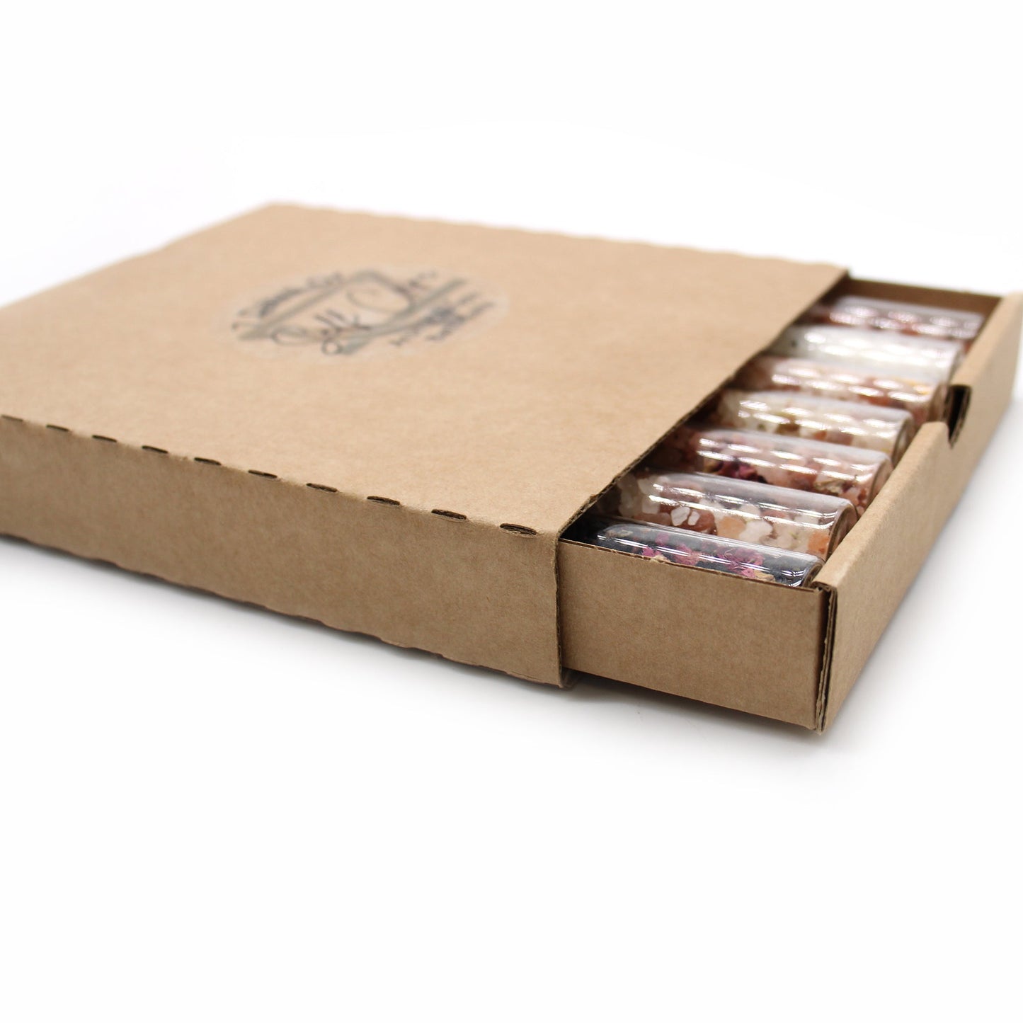 Gift Set of 7 Essential Oil Bath Salts in Vials, visible inside an open rectangular cardboard box, by Quintessential Holistic Health Ltd