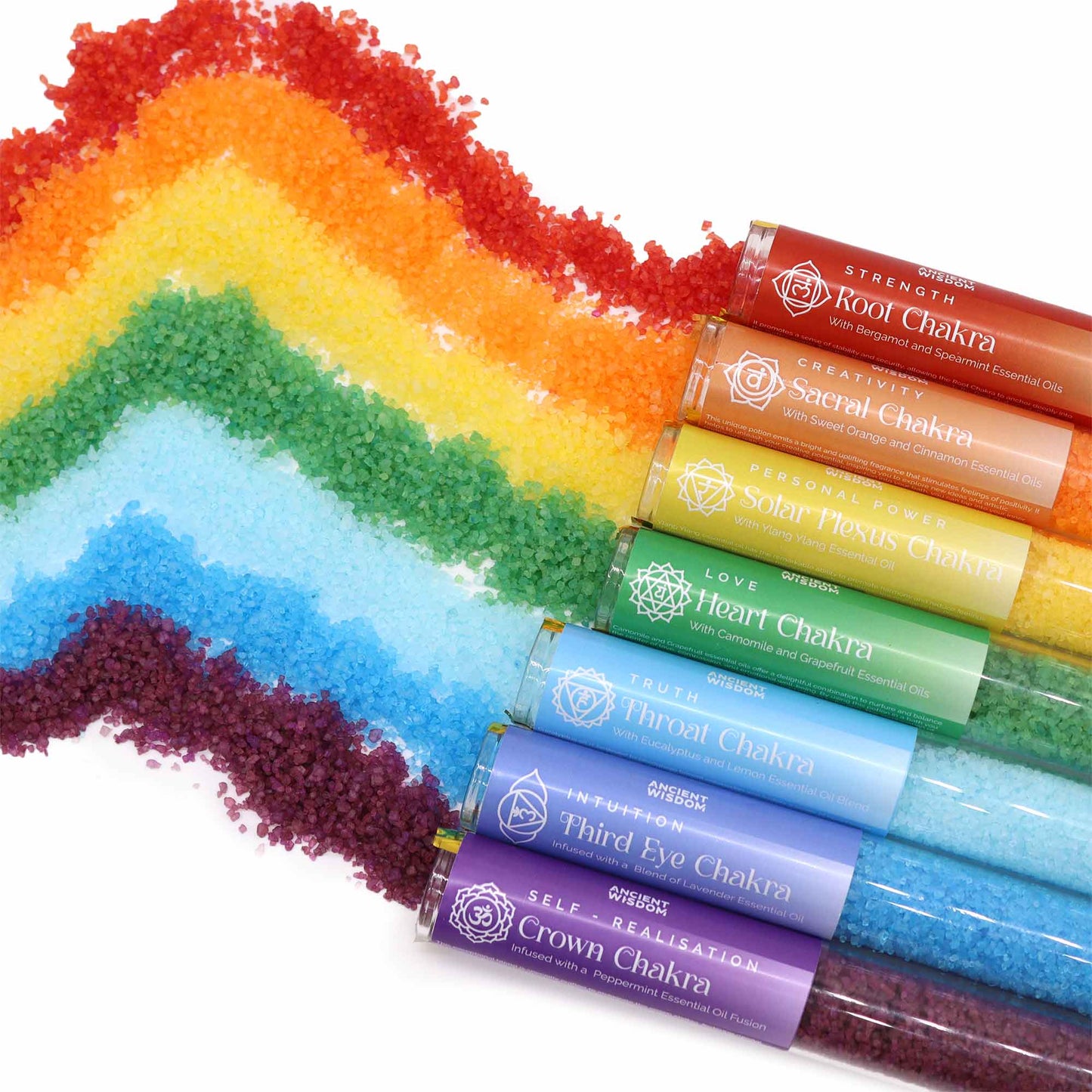 Seven Chakra Essential Oil Bath Salts Gift Set, with rainbow bands of crystals beside seven matching tubes by Quintessential Holistic Health Ltd
