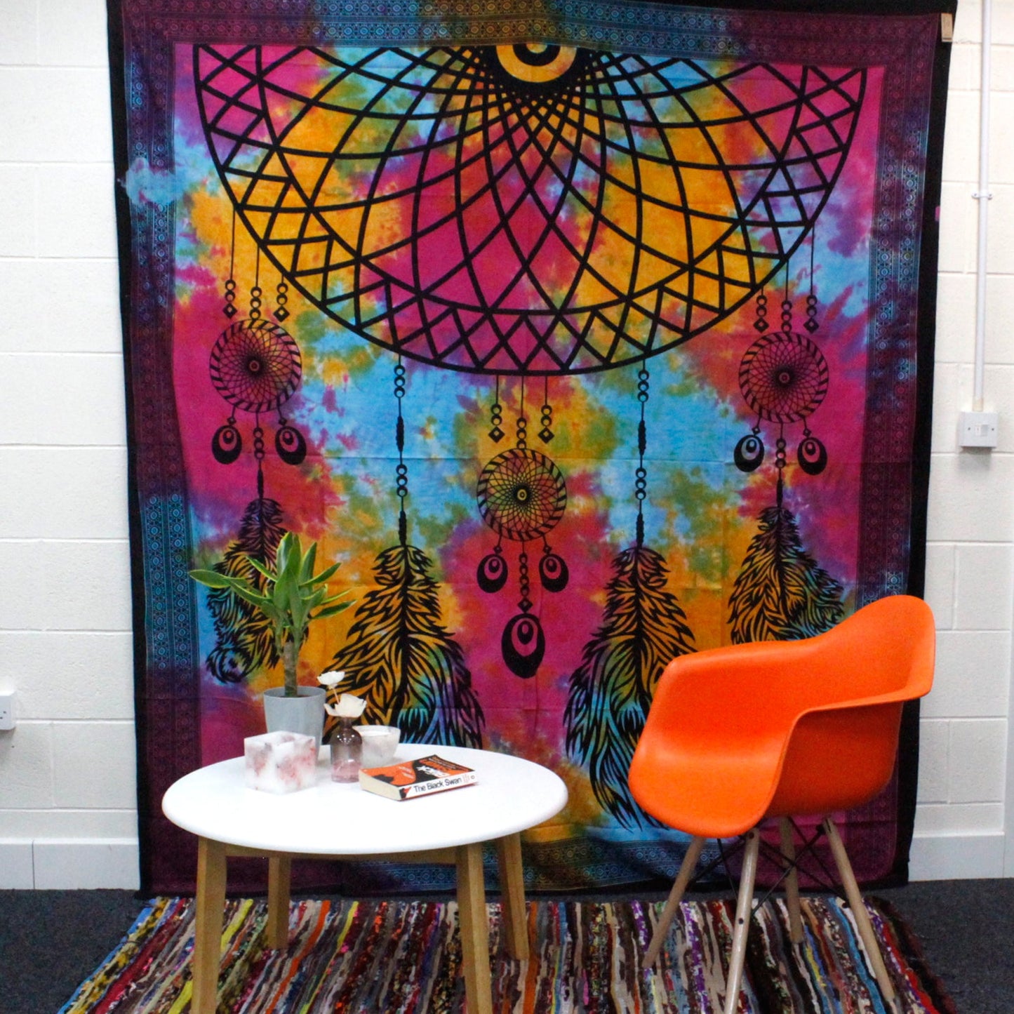 Double Cotton Wall Hanging or Bedspread - Dreamcatcher displayed behind an orange chair and white table by Quintessential Holistic Health Ltd