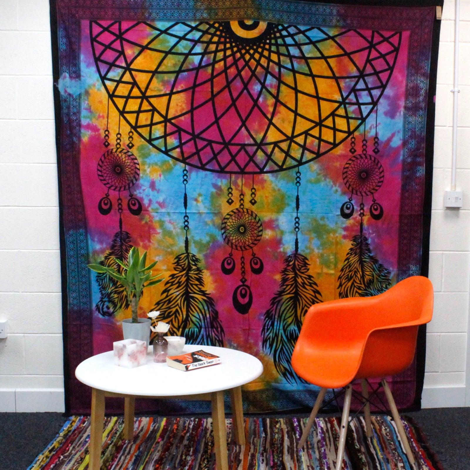 Double Cotton Wall Hanging or Bedspread - Dreamcatcher displayed behind an orange chair and white table by Quintessential Holistic Health Ltd