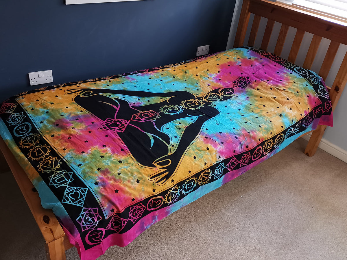 Cotton Wall Hanging or Bedspread - Single - Chakra Buddha, spread over a single bed with a seated figure on a rainbow field by Quintessential Holistic Health Ltd