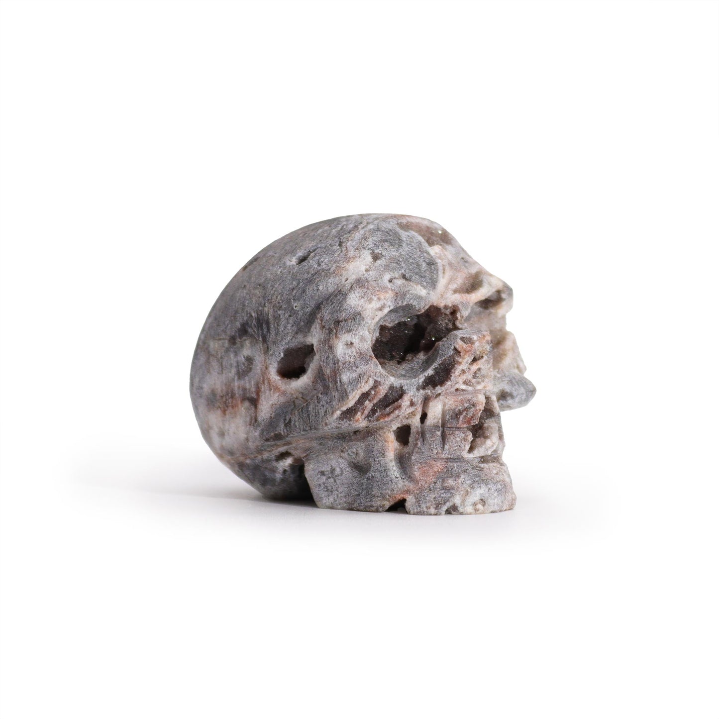 Hand Carved Natural Calcite Skull product packaging on clean background from Quintessential Holistic Health Ltd