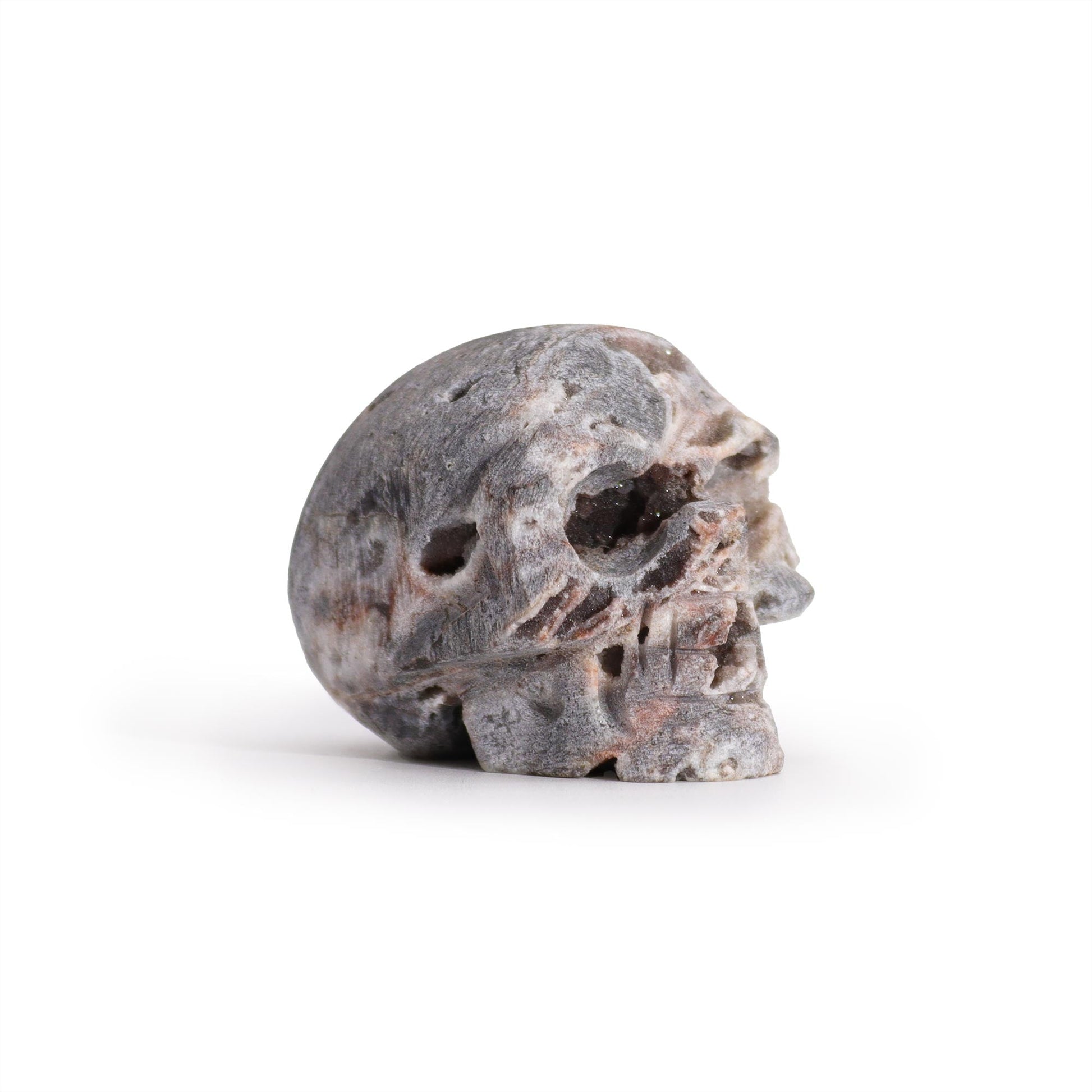 Hand Carved Natural Calcite Skull product packaging on clean background from Quintessential Holistic Health Ltd