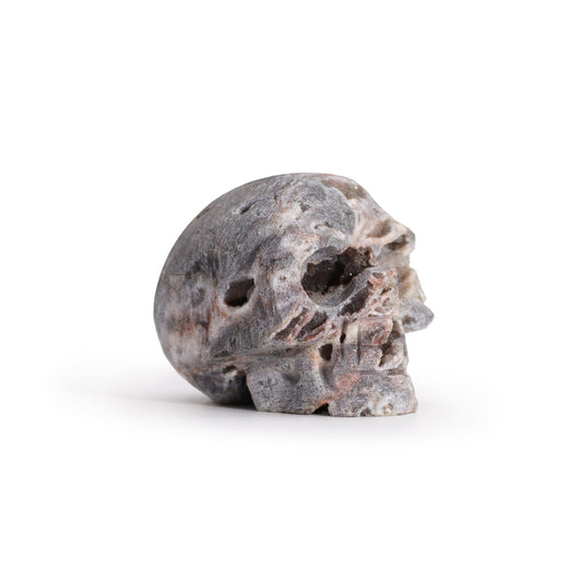 Hand Carved Natural Calcite Skull product packaging on clean background from Quintessential Holistic Health Ltd