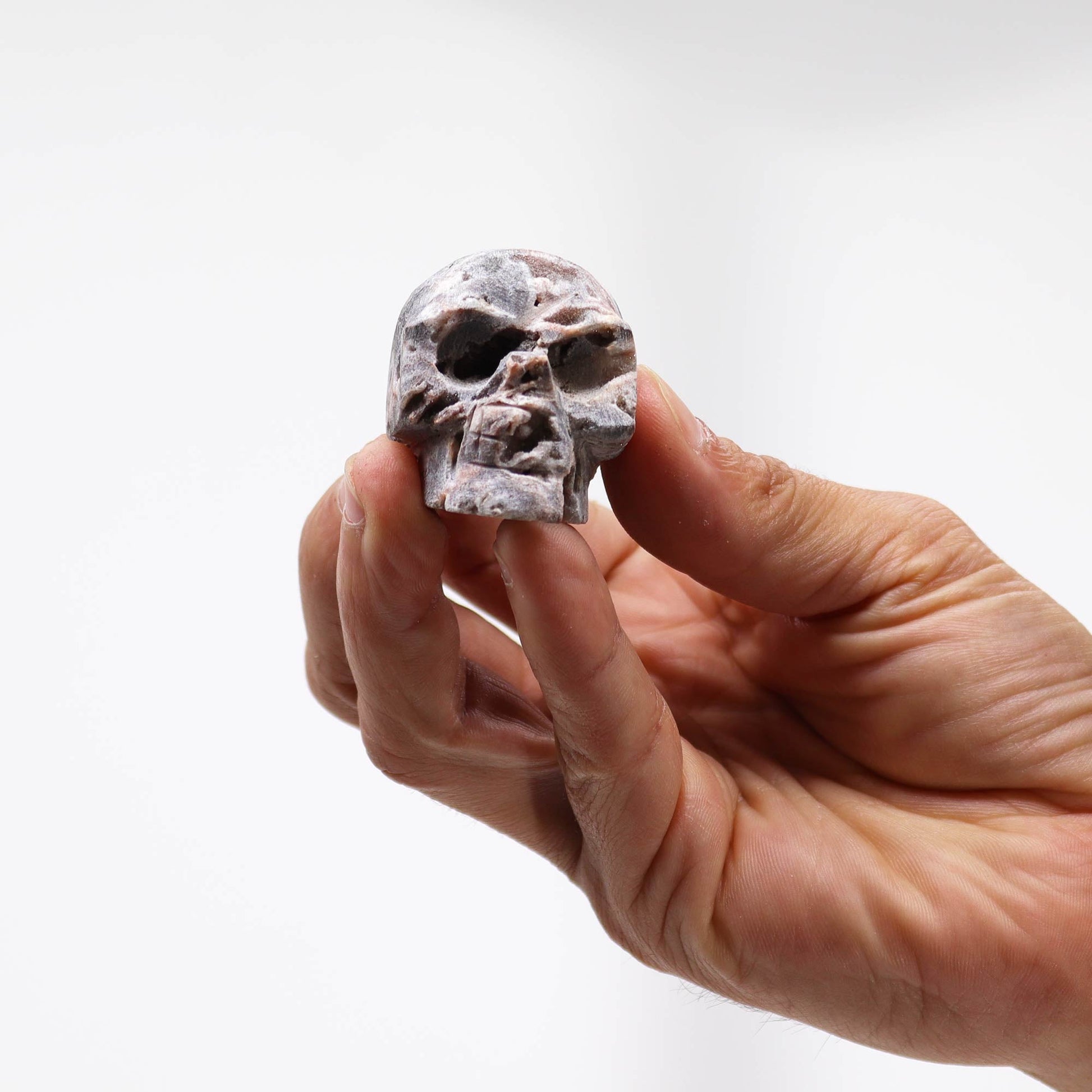 Hand Carved Natural Calcite Skull product packaging on clean background from Quintessential Holistic Health Ltd