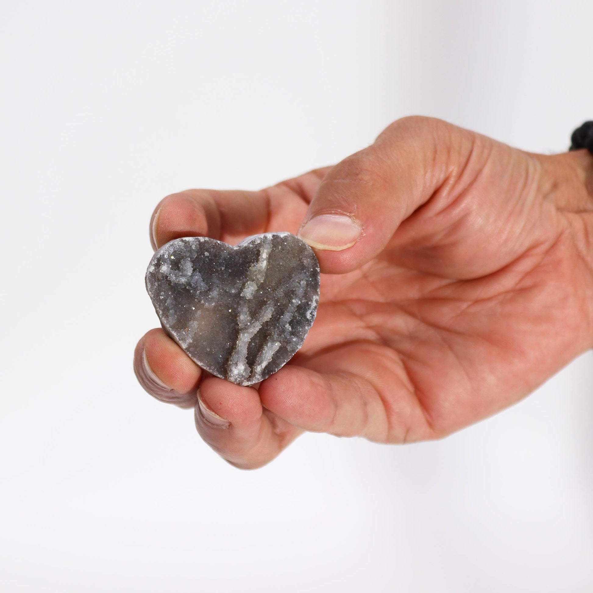 Hand Carved Natural Calcite Heart - Small product packaging on clean background from Quintessential Holistic Health Ltd