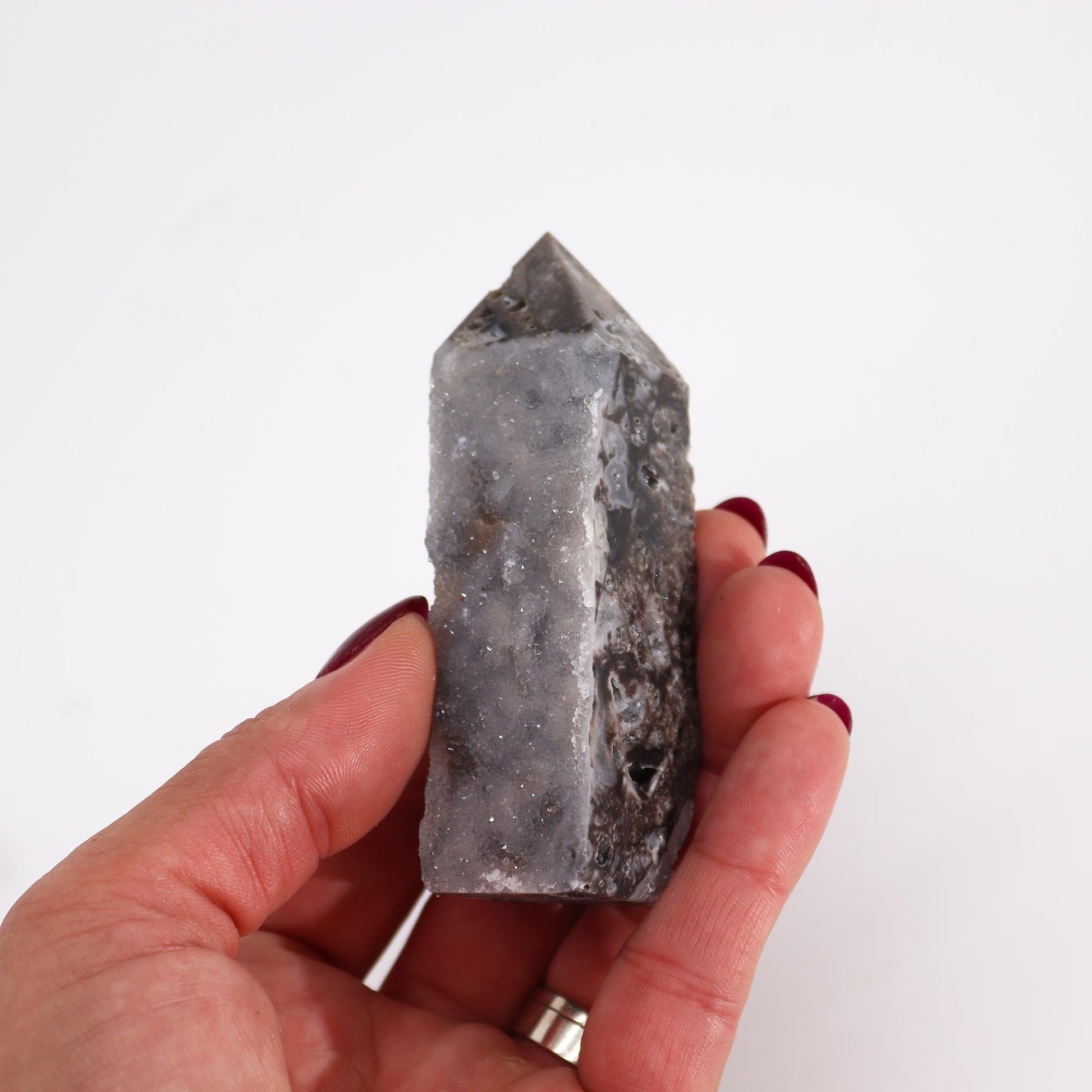 Hand Carved Natural Calcite Side Polished Tower product packaging on clean background from Quintessential Holistic Health Ltd