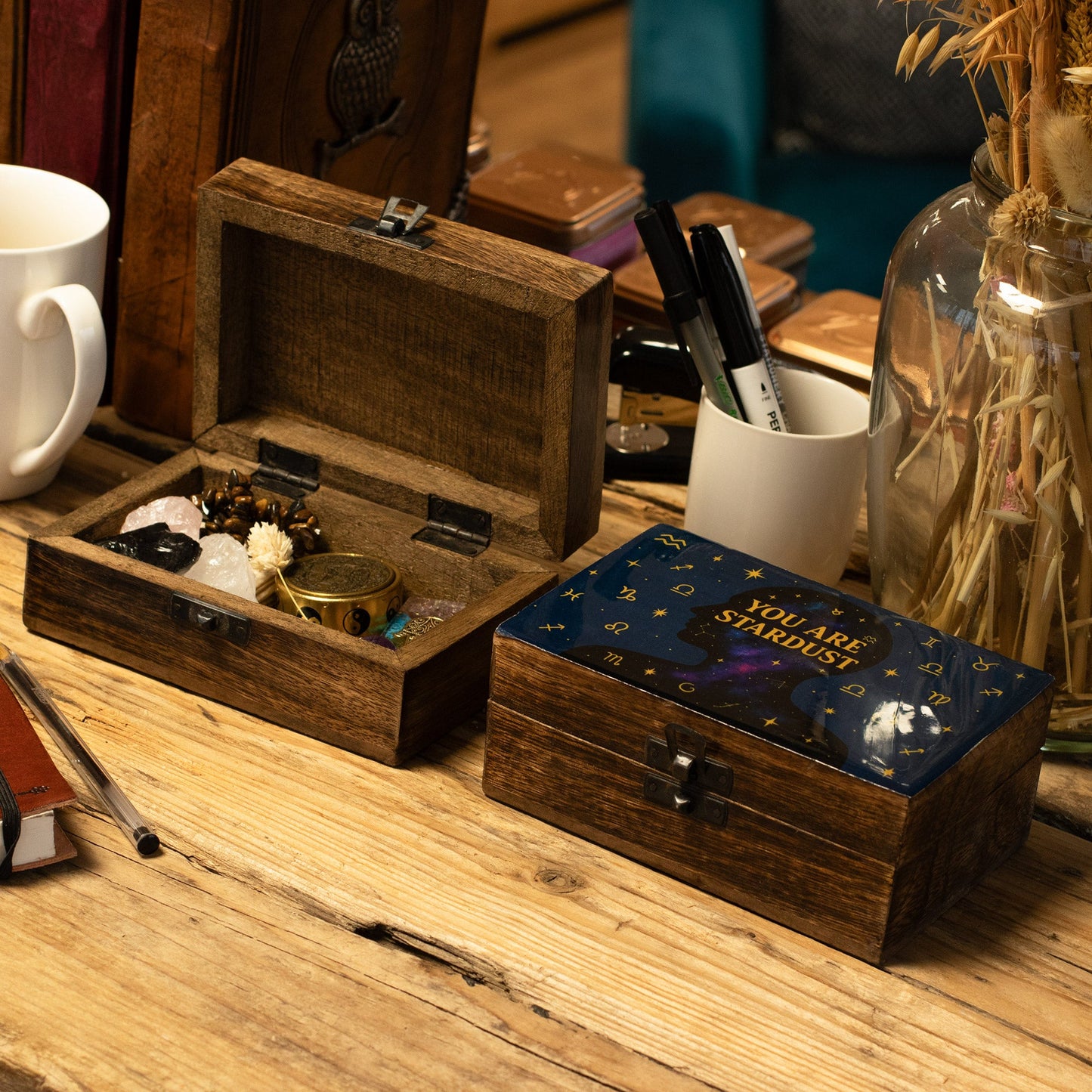 Enamelled Mango Wood Box - Medium Rectangular - You Are Stardust, closed beside an open wooden box on a worktable by Quintessential Holistic Health Ltd