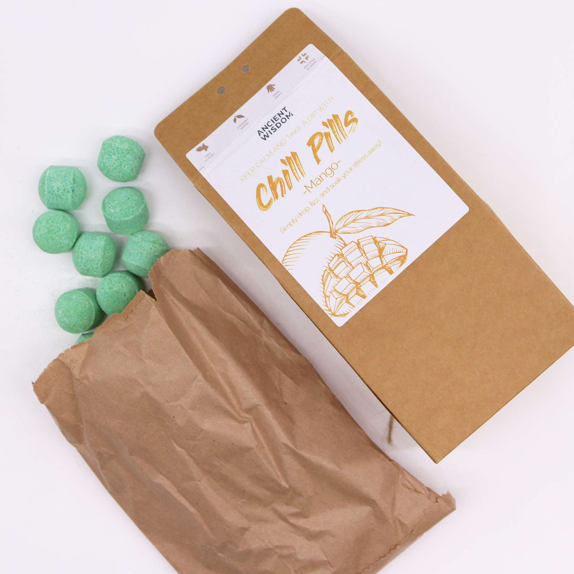 Vegan Bath Bomb Chill Pills Gift Pack - Mango - 350g, open kraft box beside a paper bag and scattered mint-green tablets, by Quintessential Holistic Health Ltd