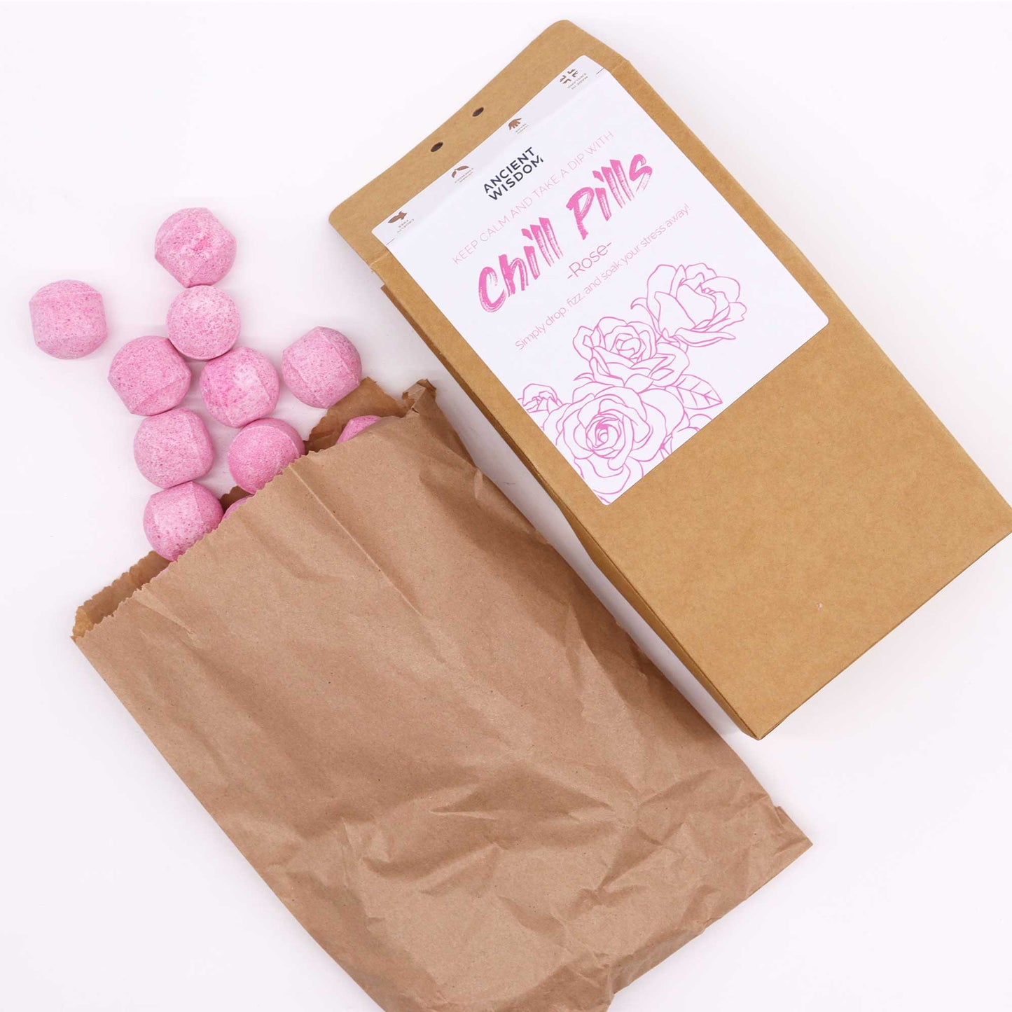 Vegan Bath Bomb Chill Pills Gift Pack - Rose - 350g, angled brown box with an open paper bag and scattered pink balls by Quintessential Holistic Health Ltd