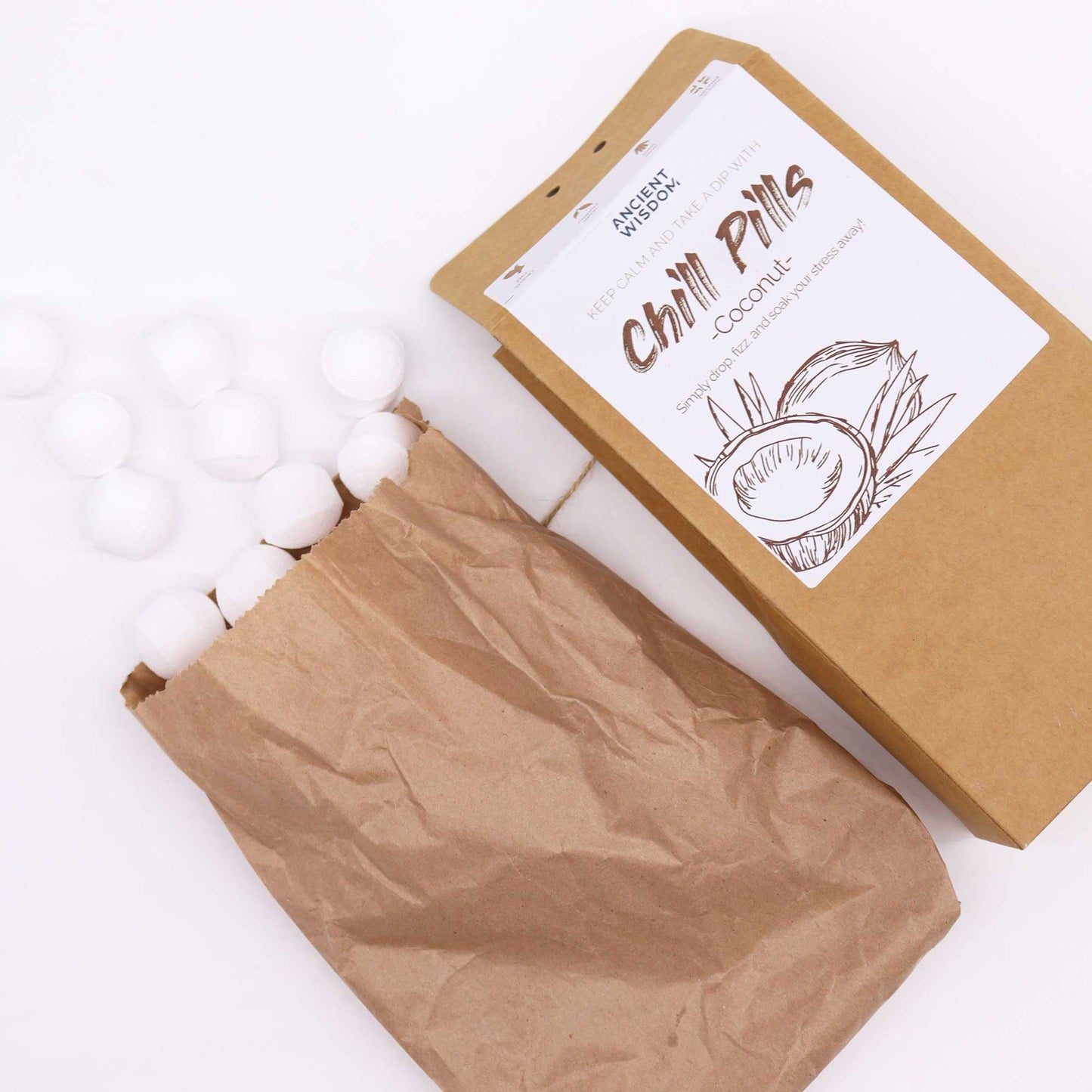 Bath Bomb Chill Pills Gift Pack - Summer of Love - 350g, angled brown box with an open paper bag and scattered white balls by Quintessential Holistic Health Ltd