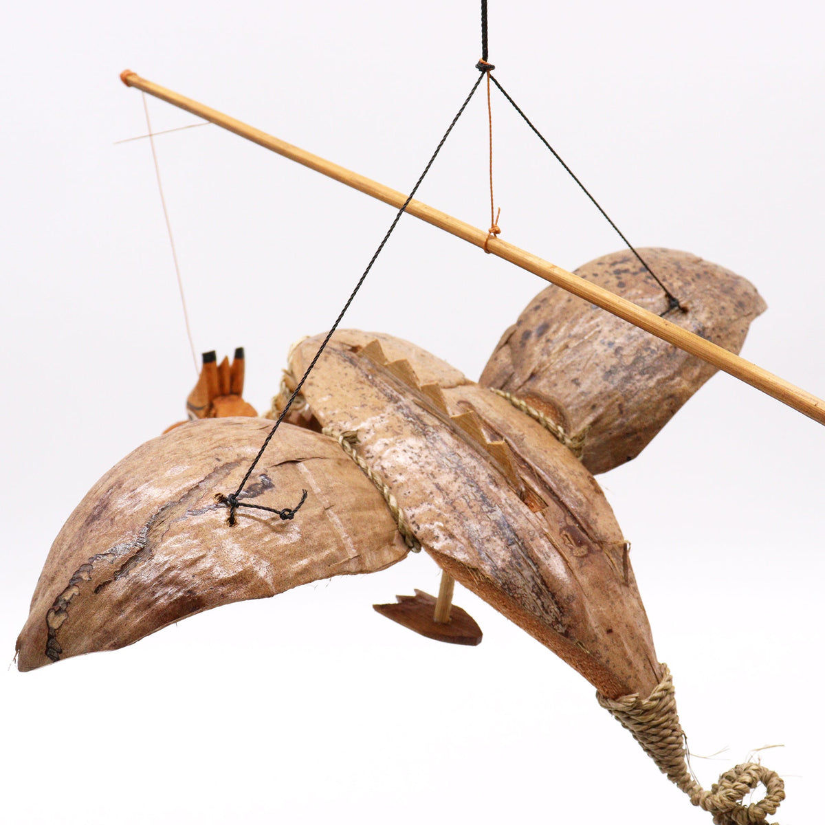 Handcrafted Coconut Shell Dragon Mobile - Natural - 37 cm showing the body and wings suspended beneath a wooden balance rod by Quintessential Holistic Health Ltd